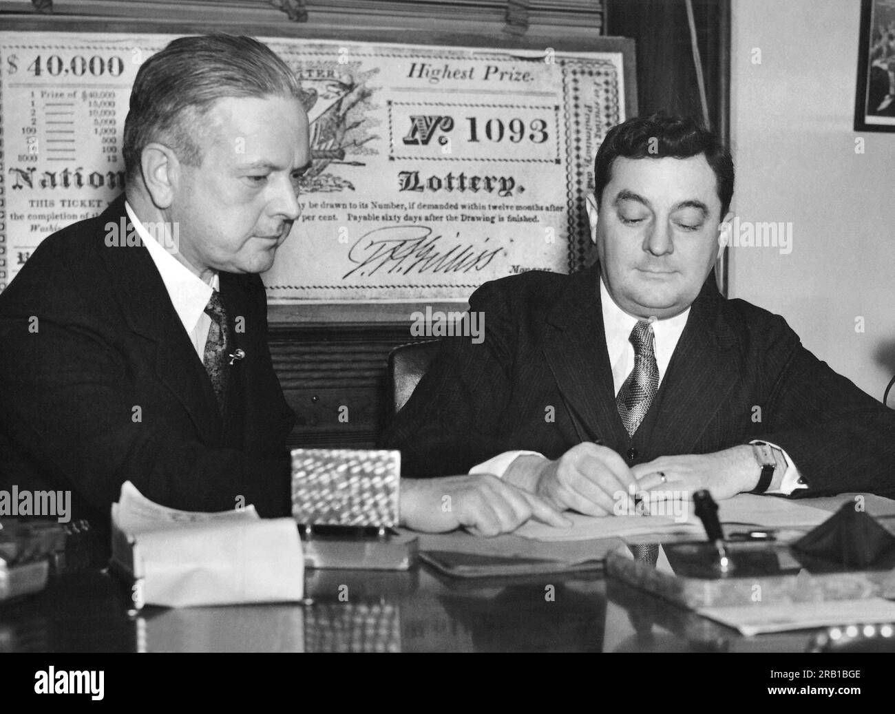 Washington, D.C.:  February 4, 1936 Congressman Edward Kenney (left) of New Jersey watches Rep. Joseph Gavagan of New York sign his petition calling for a vote on a national lottery to fund the WWI  Bonus Army payment. Stock Photo