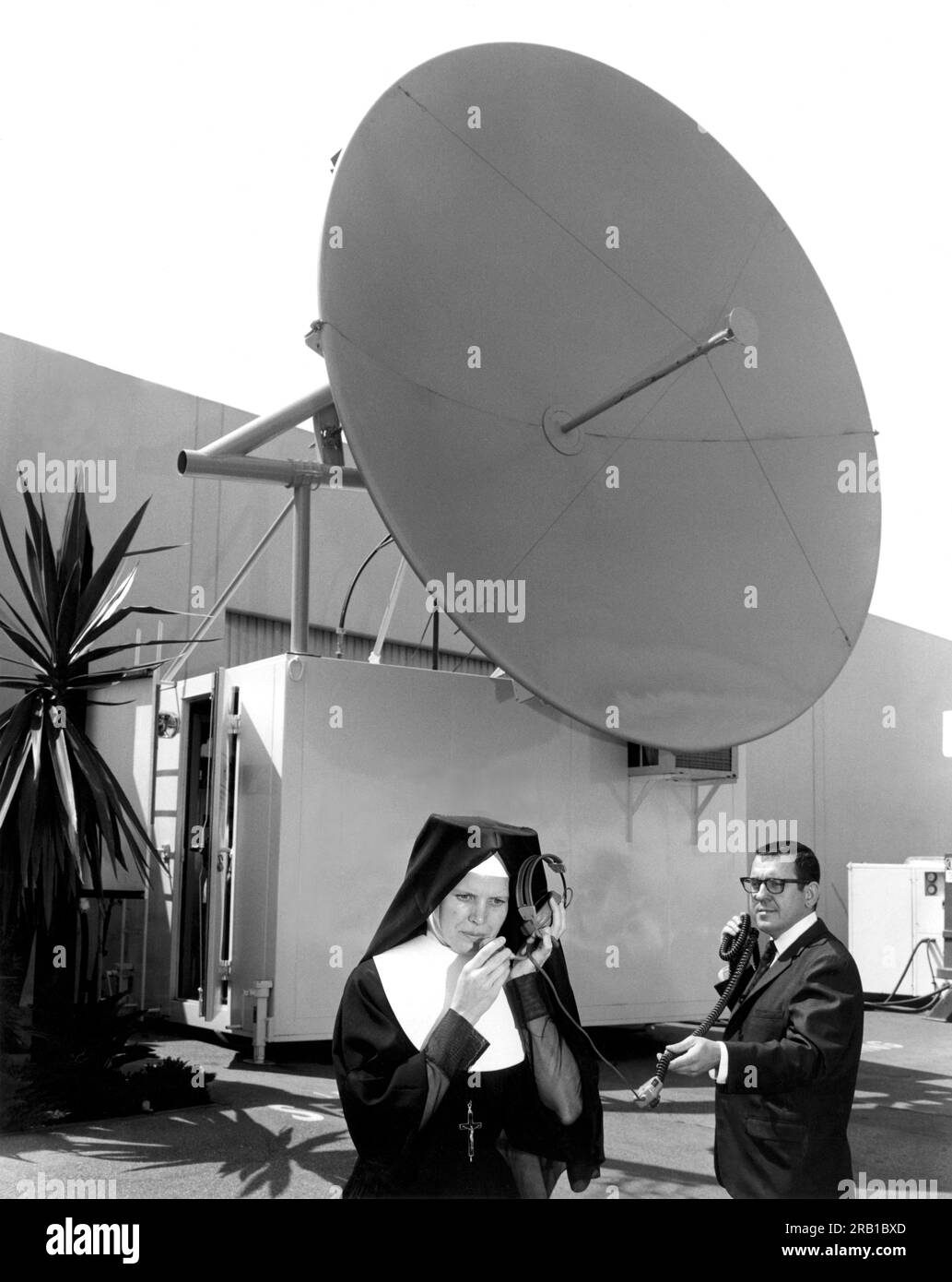 El Segundo, California:  August 6, 1968 This mobile TV satellite gorund station will be installed in Bogota, Columbia to transmit live color television coverage of Pope Paul VI's visit there later this month. Here it is being demonstrated to Sister Cecilia Louise, the president of Mount St. Mary's college in Los Angeles. Stock Photo