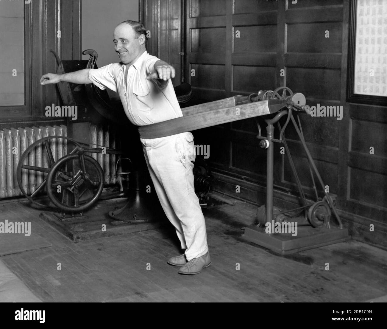 Chicago, Illinois:  October 21, 1927. One of the businessmen that patronizes the Chicago Athletic Club using the new vibrating belt machine. Stock Photo