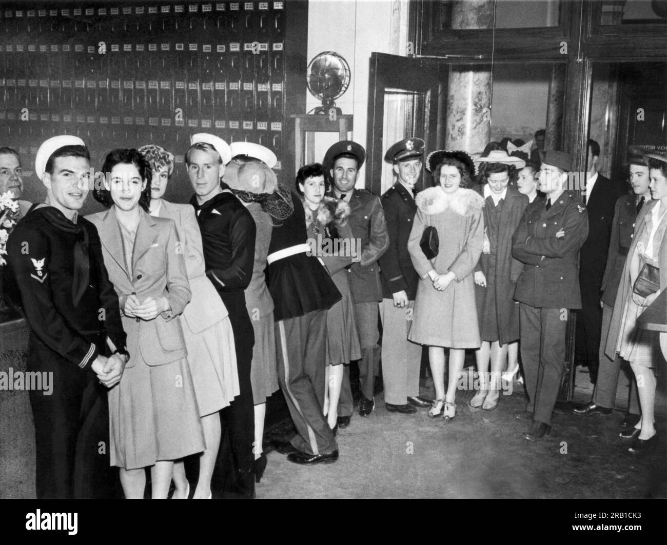 Reno, Nevada: c. 1940 Soldiers, sailors and marines stand in line to