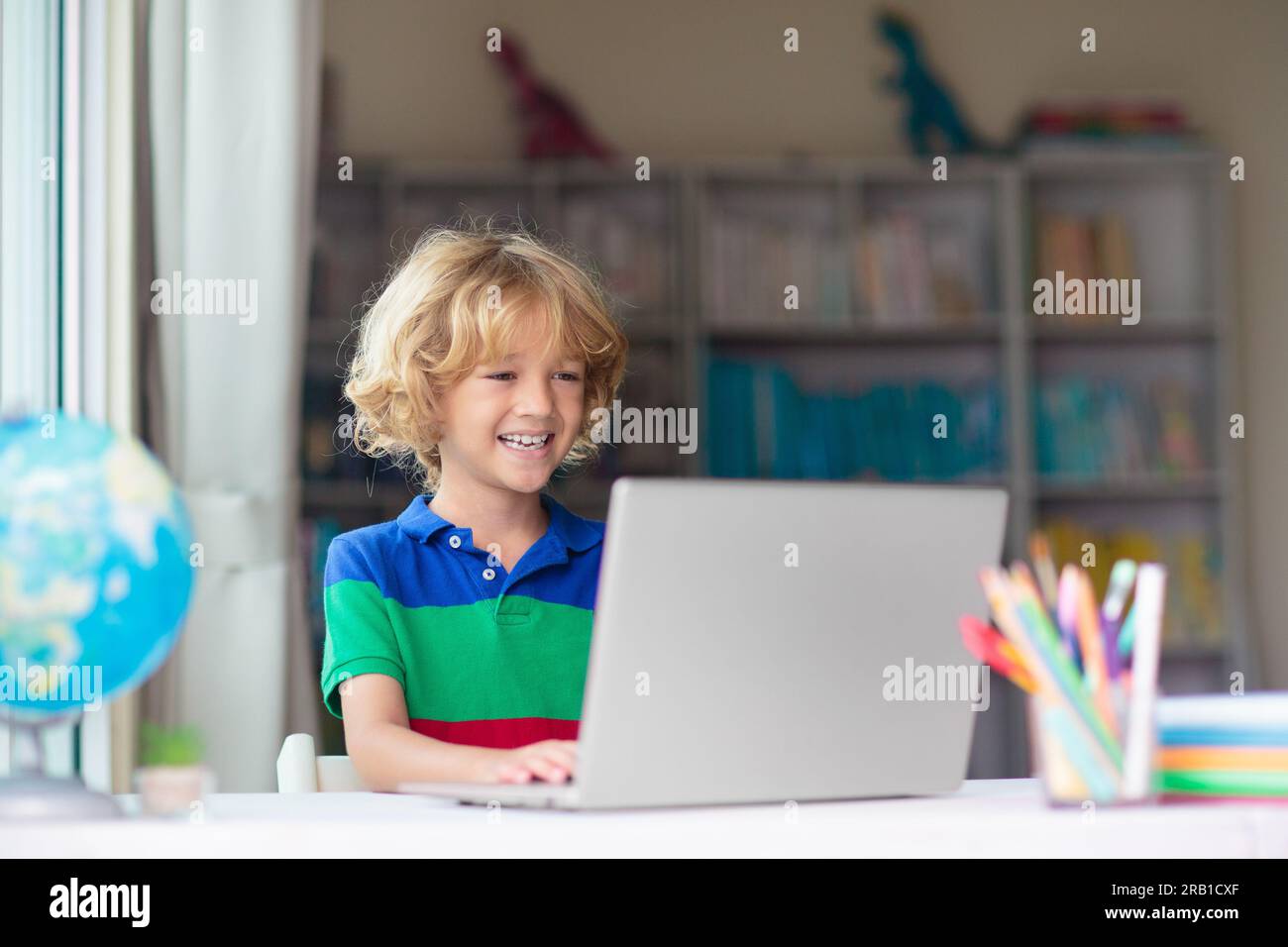 Child doing homework on computer. Online class. Homeschooling and ...