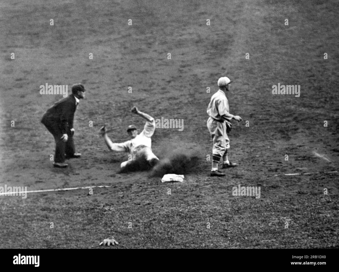 New York, New York:  October  5, 1928 Yankee left fielder Bob Meusel slides safely into third base in the seventh inning of the second game of the World Series at Yankee Stadium between the New York Yankees and the New York Giants. Stock Photo