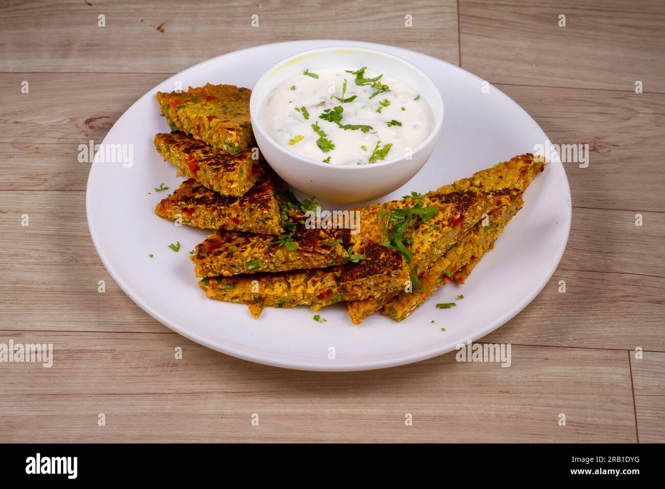 Oats Cheela in white plate on wooden background Stock Photo