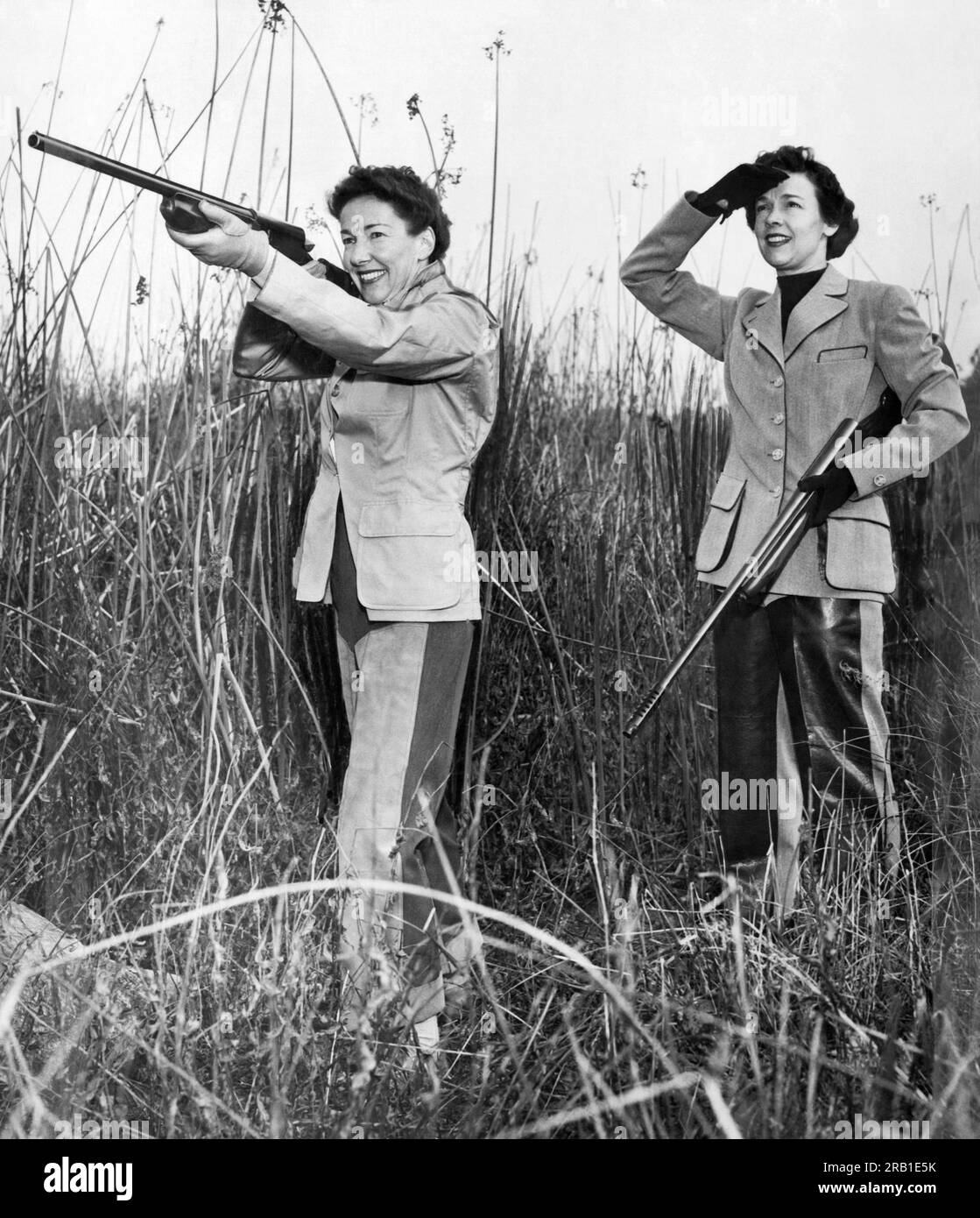 San Francisco, California:   1953 Two women out hunting in a field. One takes aim as the other watches. Stock Photo