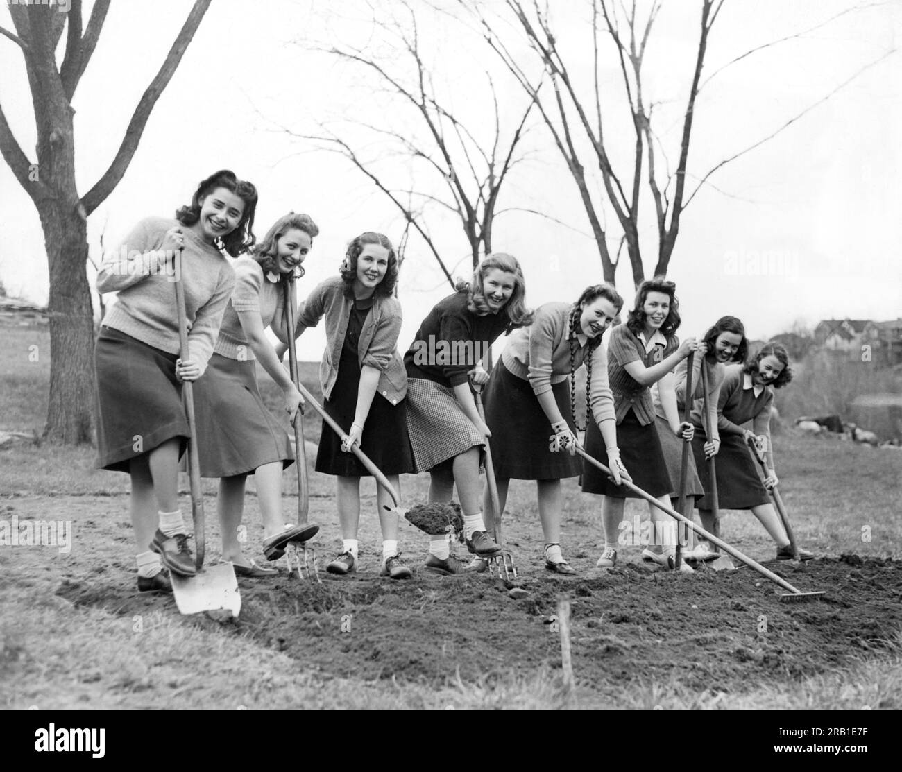 White Plains, New York:  April 23, 1942 Freshmen girls at Good Counsel College break ground for a WWII victory vegetable garden on their 40 acre campus. Stock Photo