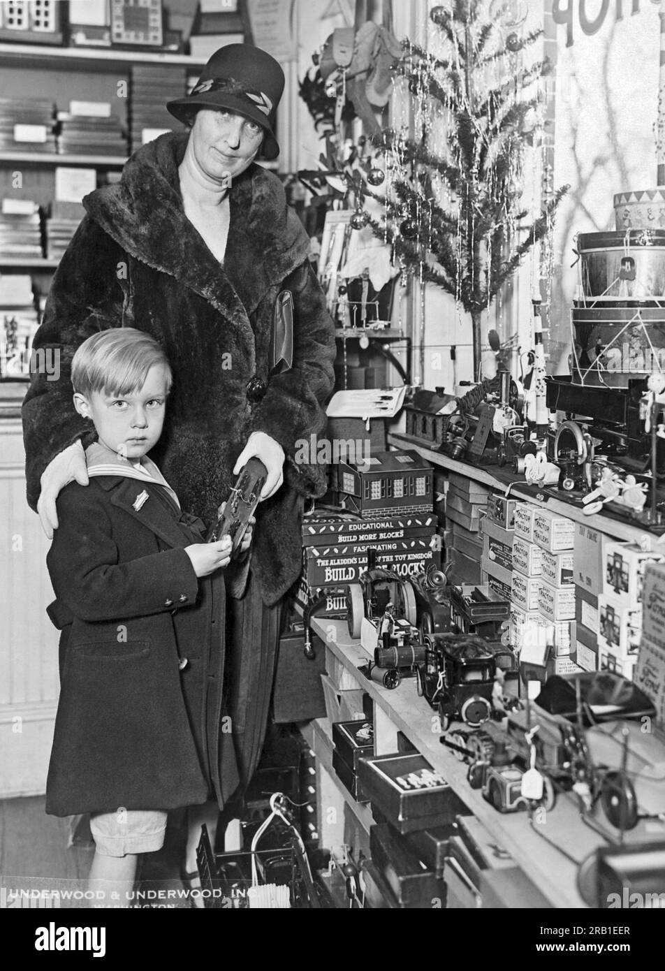 Washington, D.C.: December 5, 1925. Freddie Hicks, son of Alien Property Custodian Hicks, gets an pre-season tour of Toyland with his mother. Stock Photo