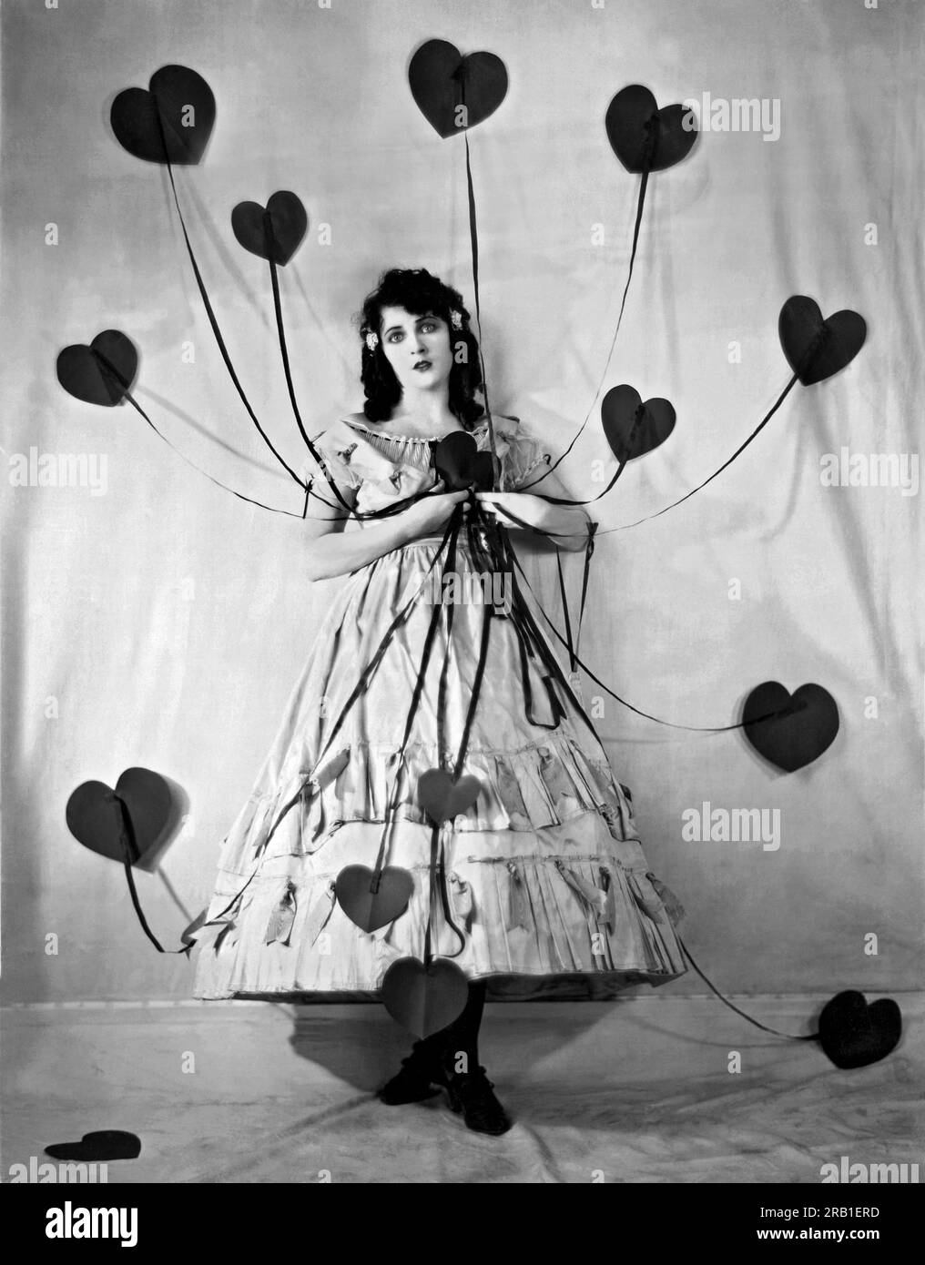 Hollywood, California:  c. 1925. Jacqueline Logan (1901-1983, silent film star, holding the multitude of hearts given to her on St. Valentine's Day. They all came with strings attached. Stock Photo