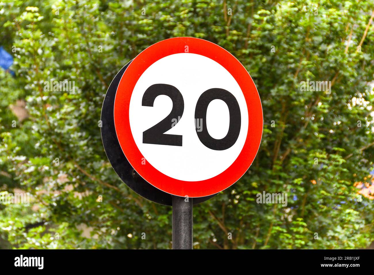 Road sign marking the start of a 20 mph speed limit zone in a