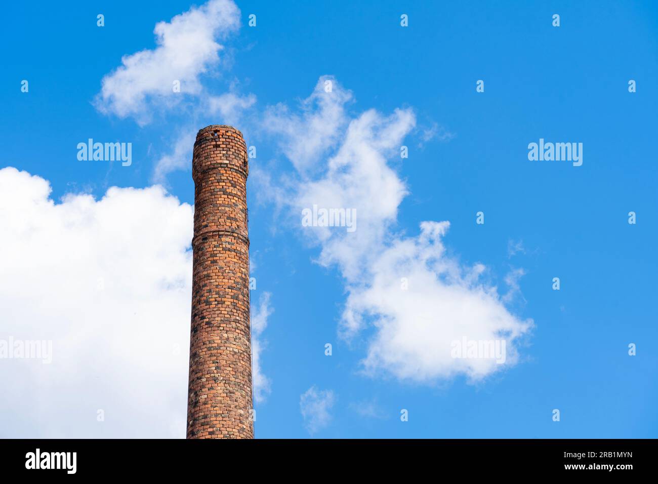 Old ruined brick chimney in front of cloudy blue sky Stock Photo - Alamy