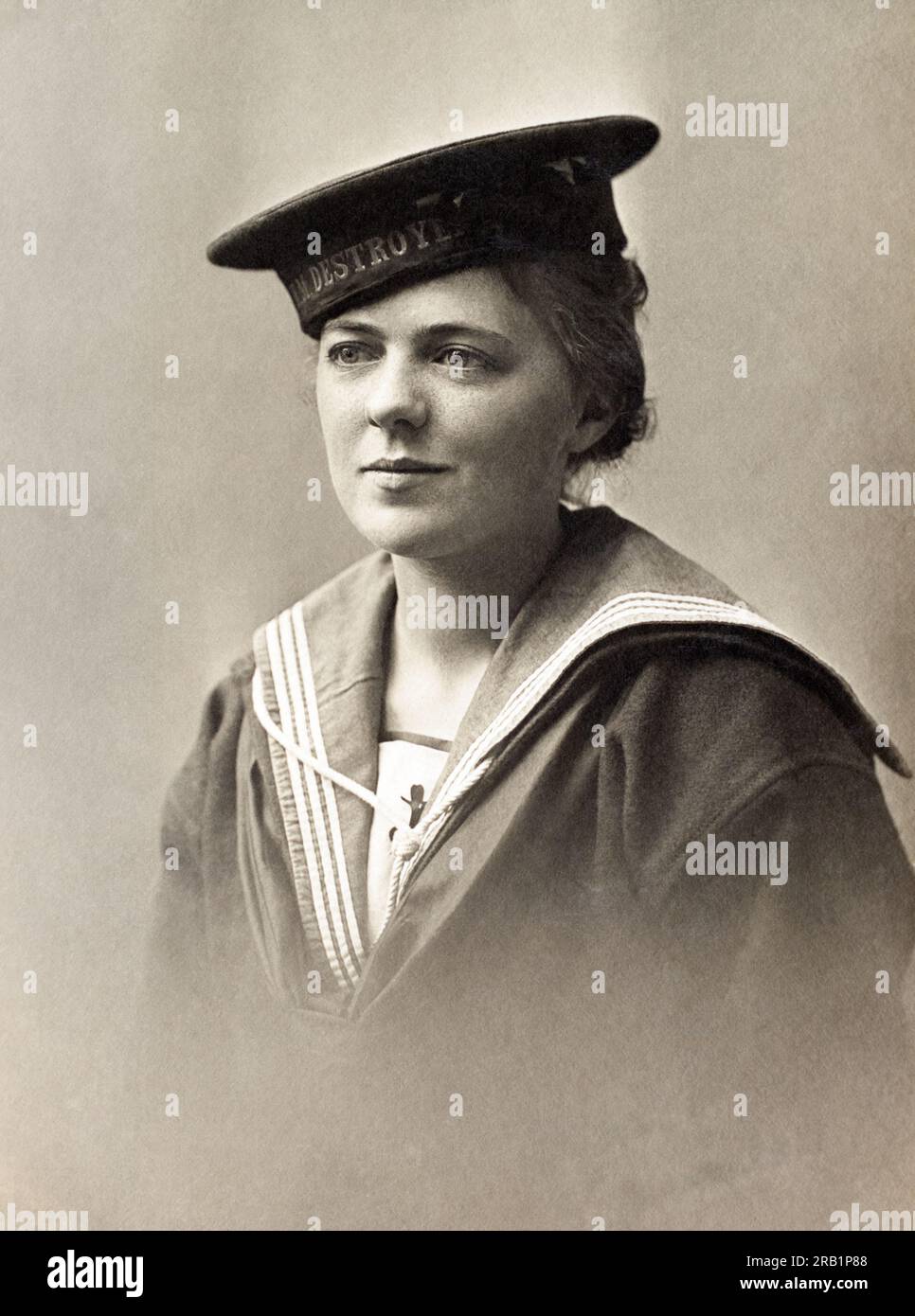 A woman in the uniform of a Royal Navy sailor with a HMS Destroyer cap tally. Stock Photo