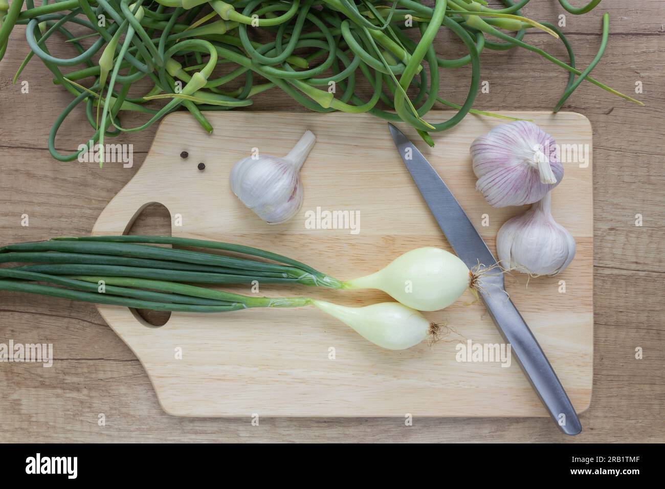Harvest of young garlic, garlic arrows, onions in the kitchen in the