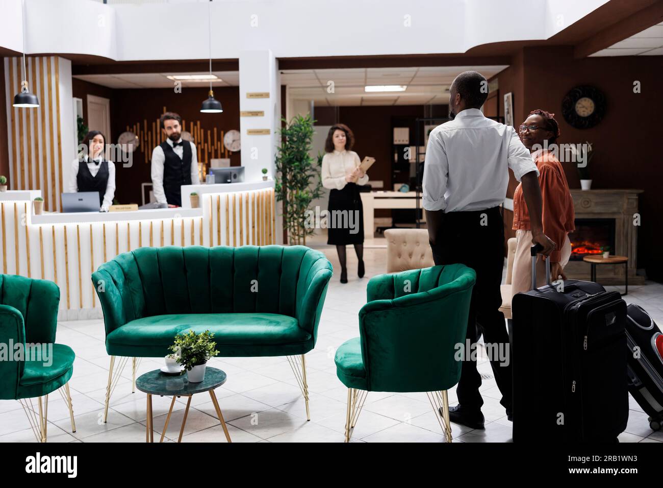 African american couple at reception, arriving at hotel and preparing ...