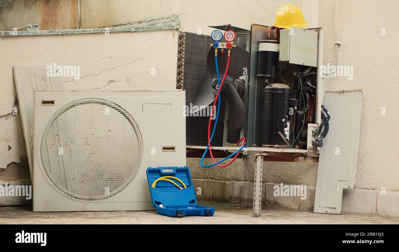 Zoom in close up shot of broken external air conditioner unit with