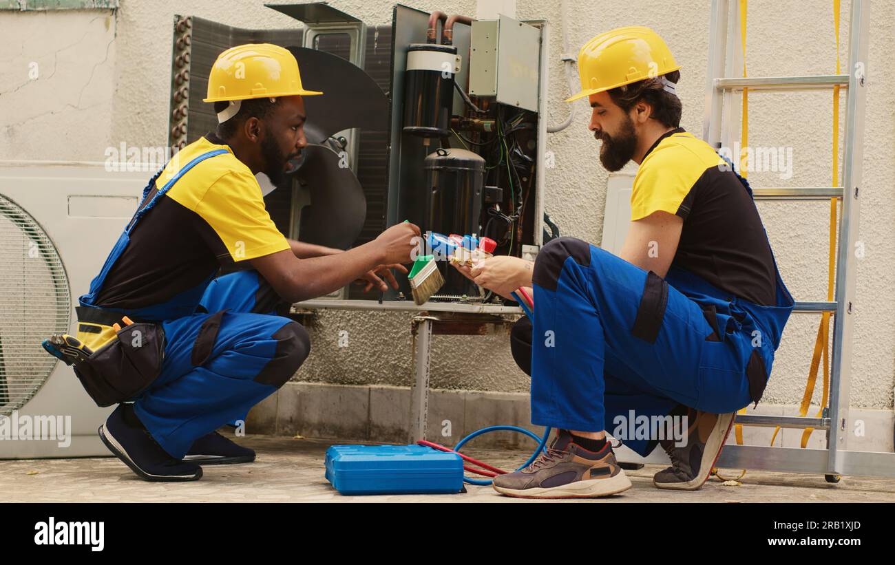 Efficient technicians assembling professional pressure manifold gauges
