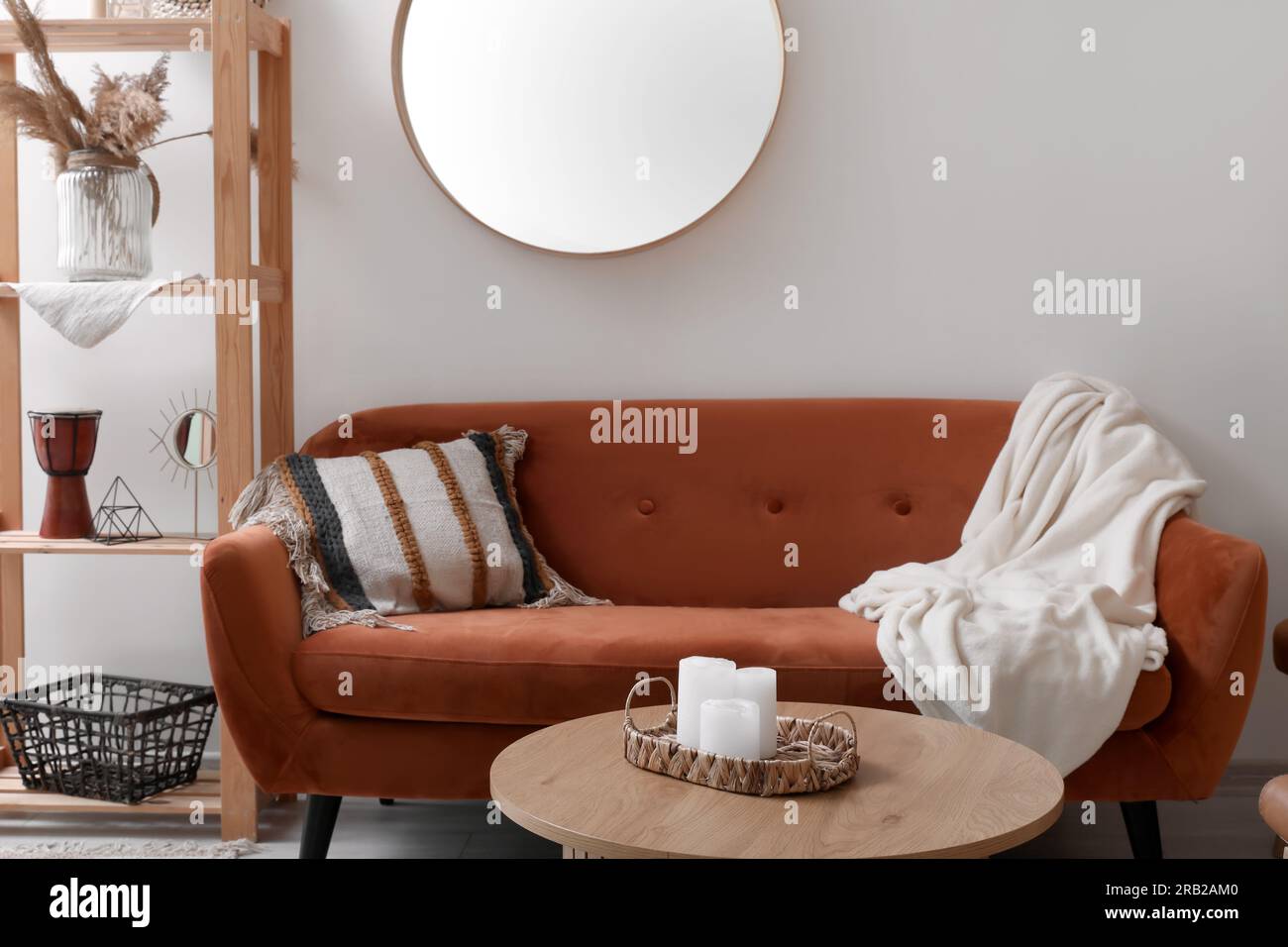 Interior of living room with brown sofa, mirror and coffee table Stock ...