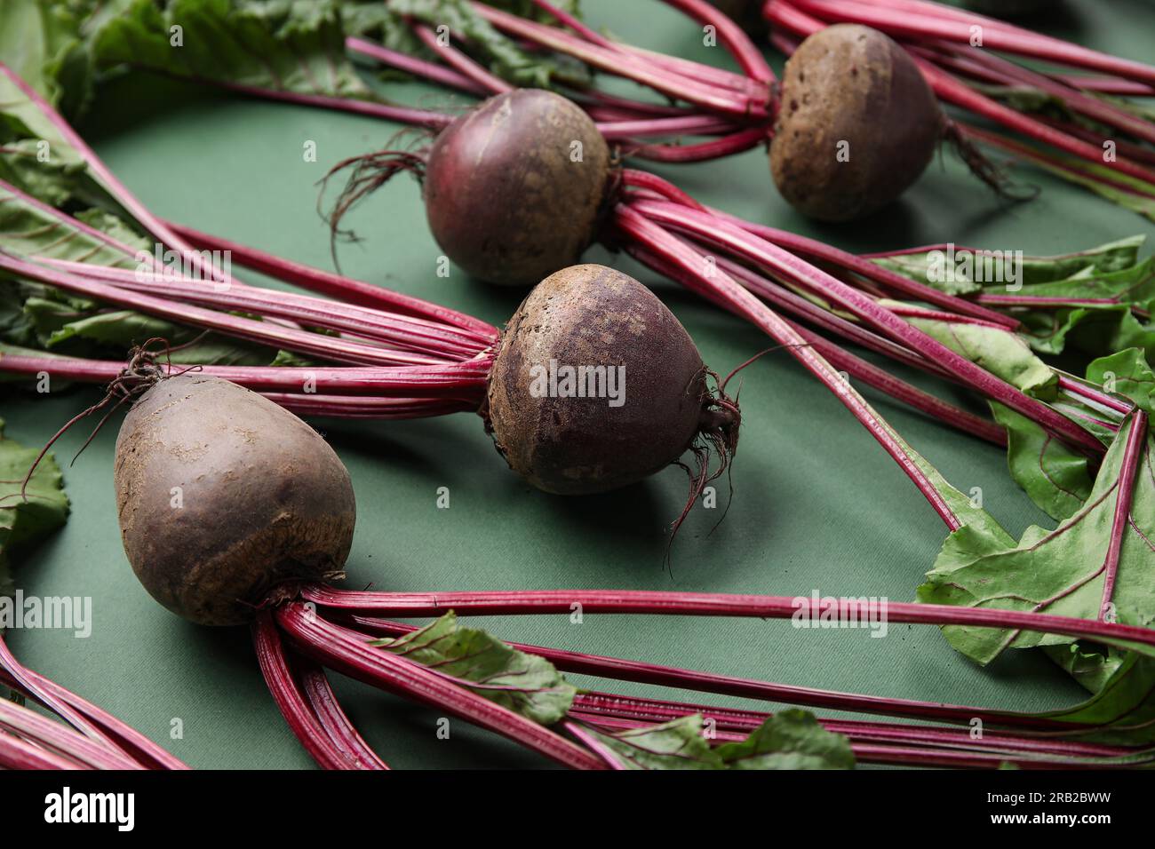 Fresh beetroots with leaves on green background Stock Photo