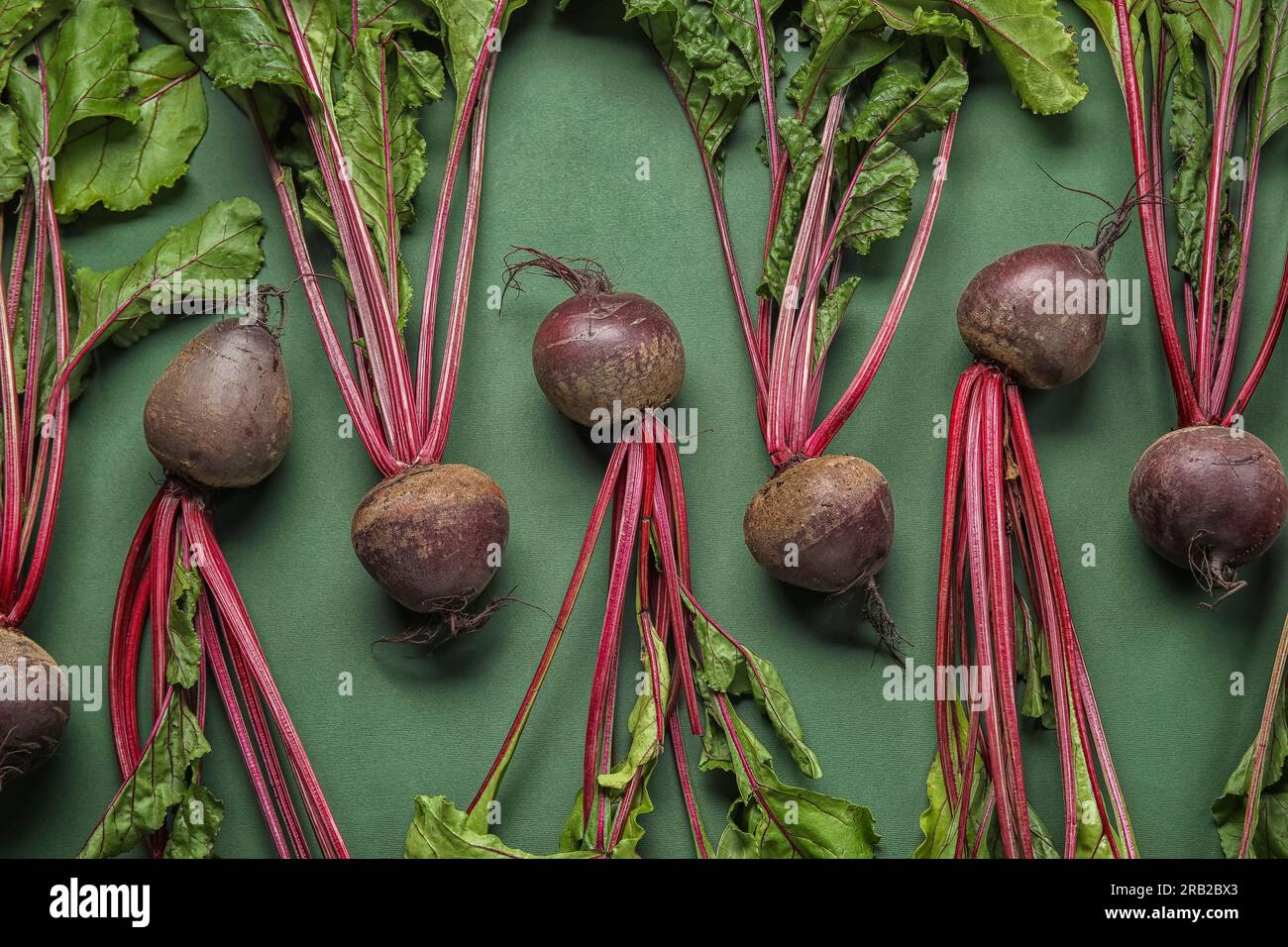 Fresh beetroots with leaves on green background Stock Photo