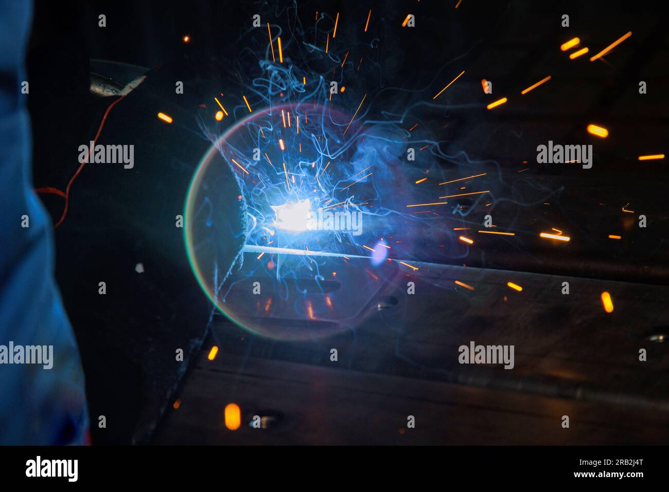 Using semiautomatic argon arc welding skilled welder executes precise