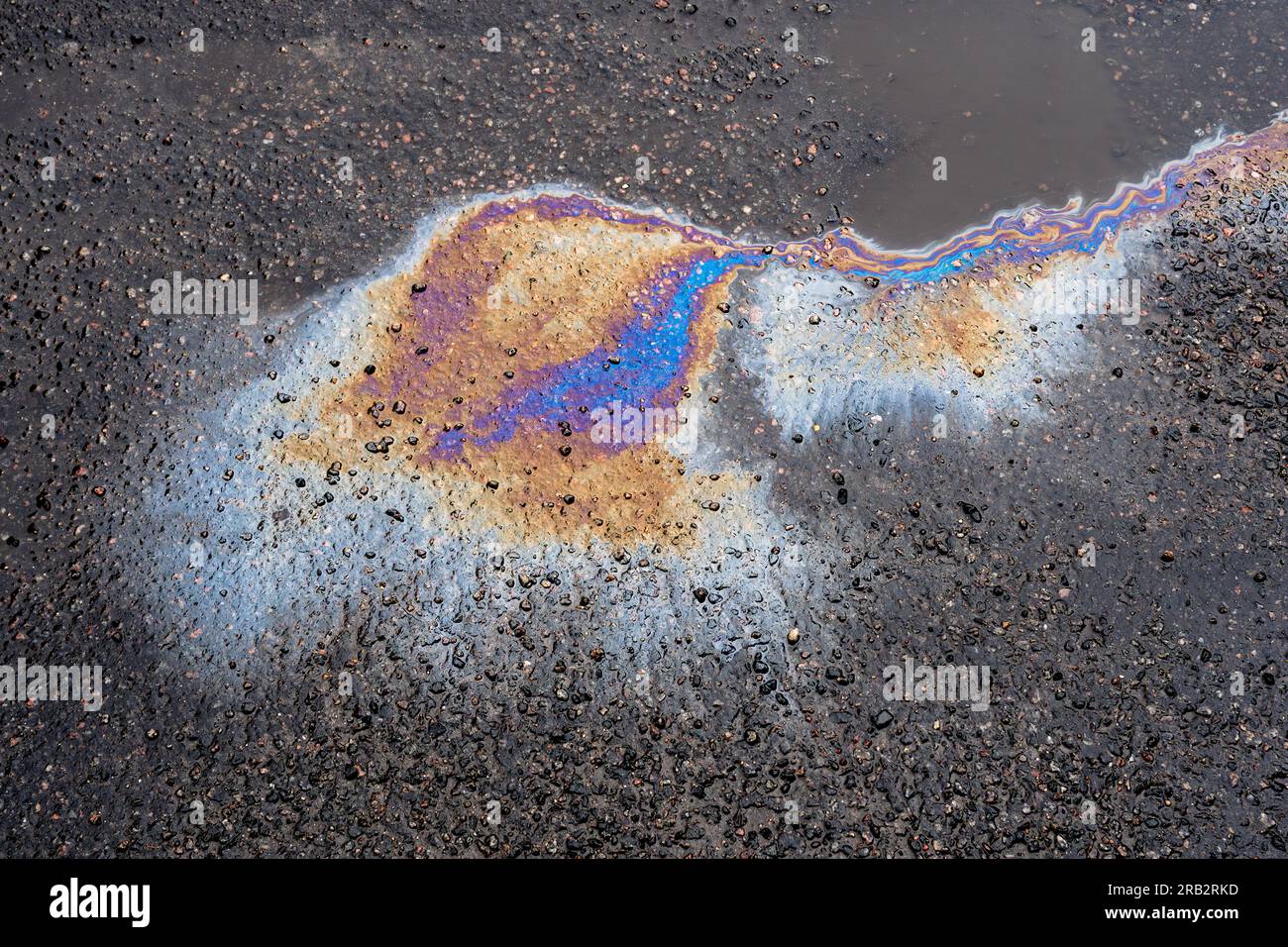 Leaked petroleum products on the roadway. Oil stains on wet asphalt