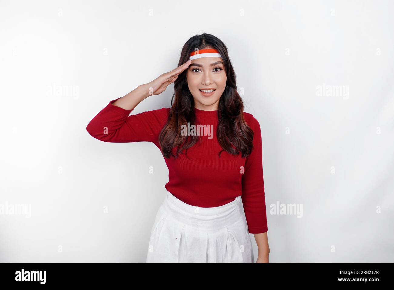 Indonesian woman looking at the camera while give salute with proud gesture Stock Photo