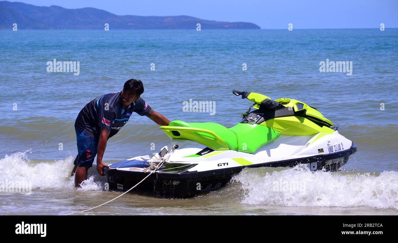 Man working to rent out jet skis in the sea on Dongtan beach in Jomtien, Pattaya, Thailand Stock Photo