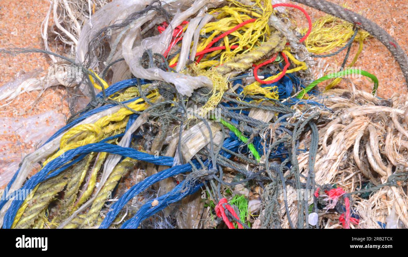 A tangle of plastic and nylon and material cords on Dongtan beach in Jomtien, Pattaya, Thailand; rubbish, refuse, beach cleanliness theme Stock Photo