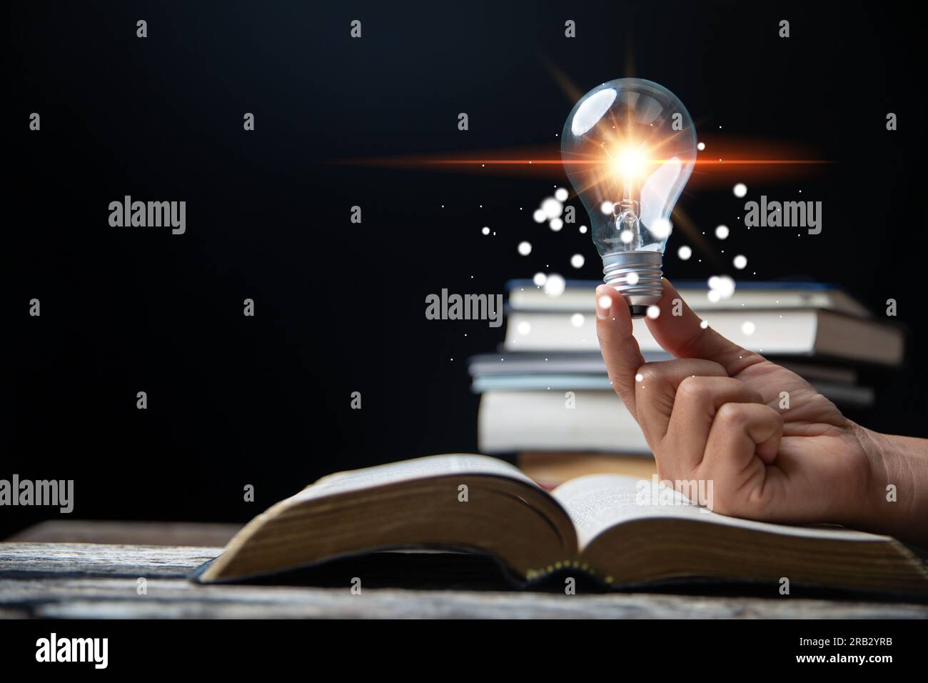 Light bulbs and books. Concept of reading books, knowledge, and searching for new ideas. Innovation and inspiration, Creativity with twinkling lights, Stock Photo