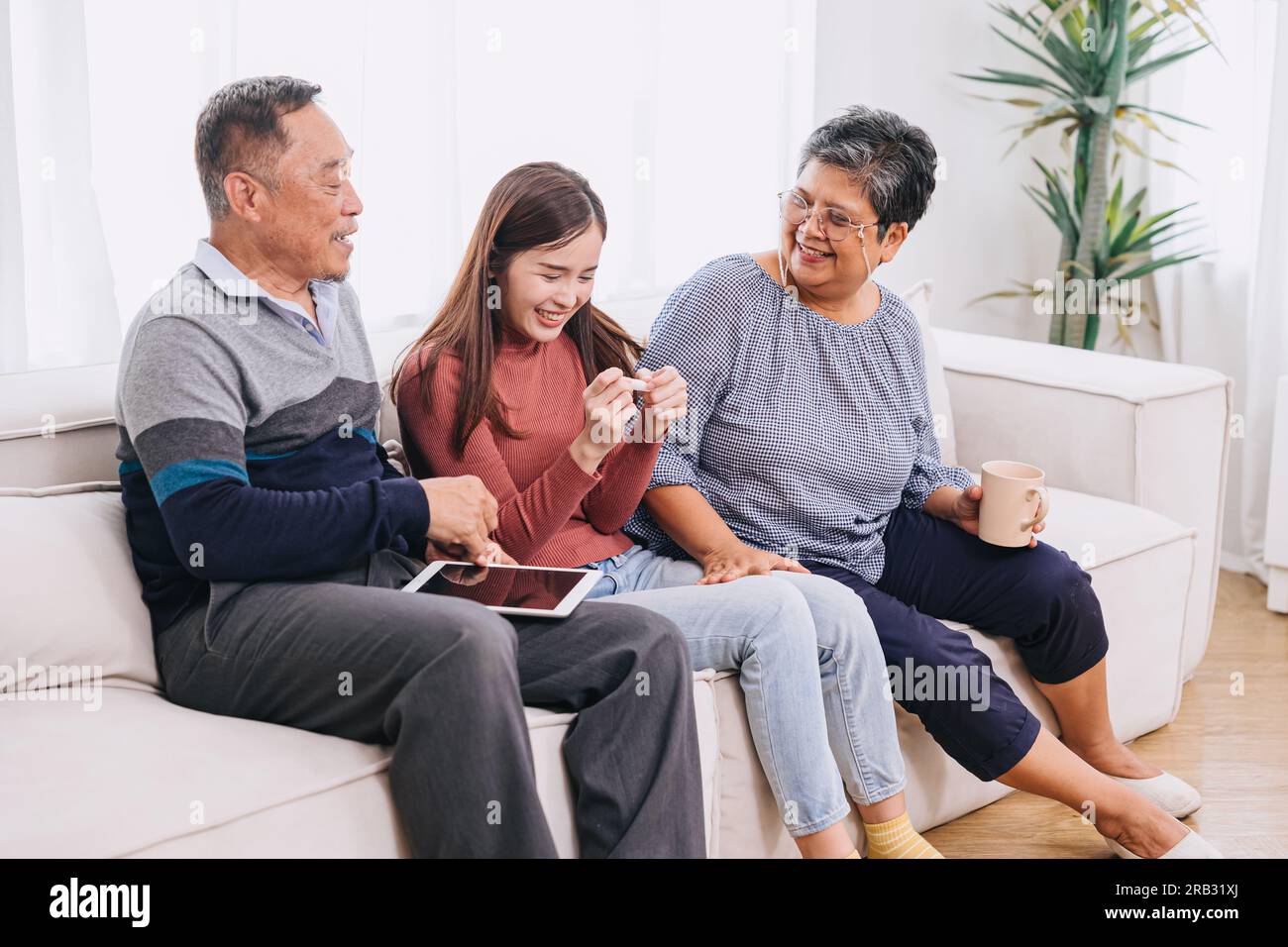 daughter asian girl teen happy exciting gladly with pregnancy test found result pregnant positive happy to have a baby good news with mature parents e Stock Photo
