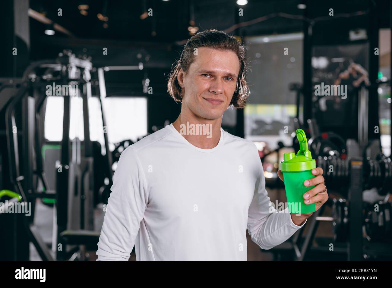 healthy sport man with whey shaker bottle. happy drinking whey protein for muscle strength mass gain and low fat beverage meal in gym fitness Stock Photo