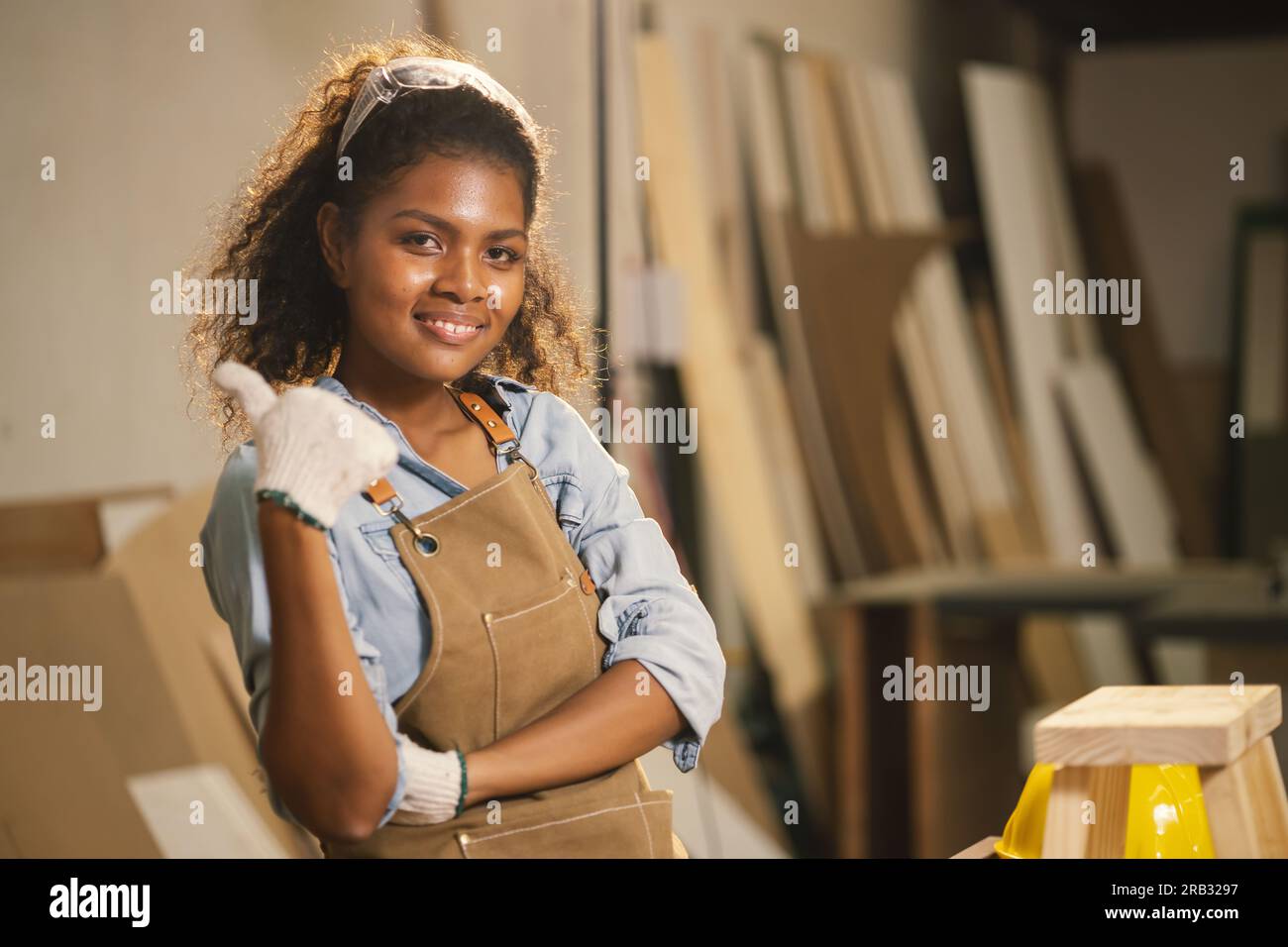Happy carpenter woman african black smiling in wood enjoy