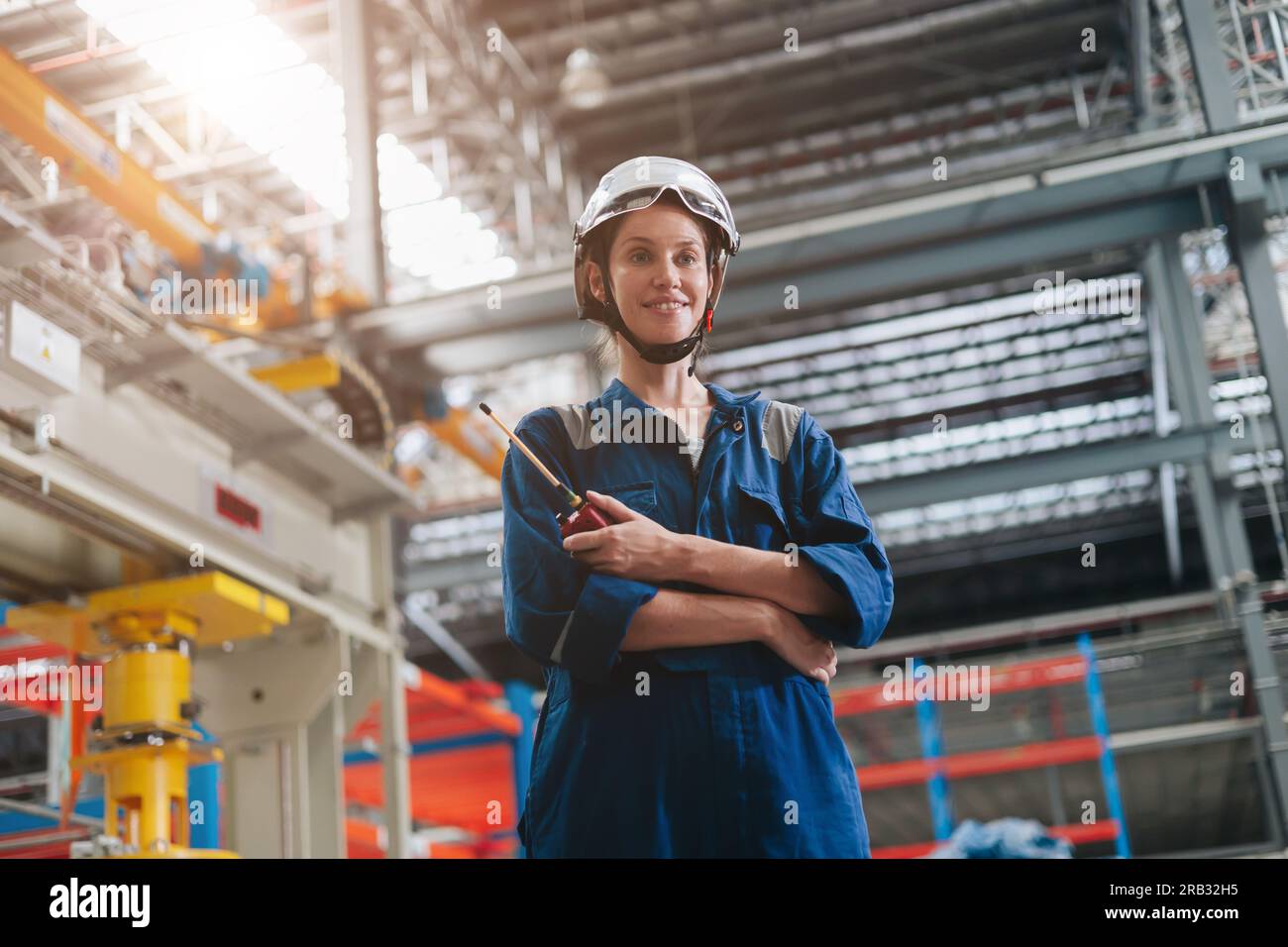 portrait engineer woman professional smart worker standing  happy smile in large industry building interior. Stock Photo