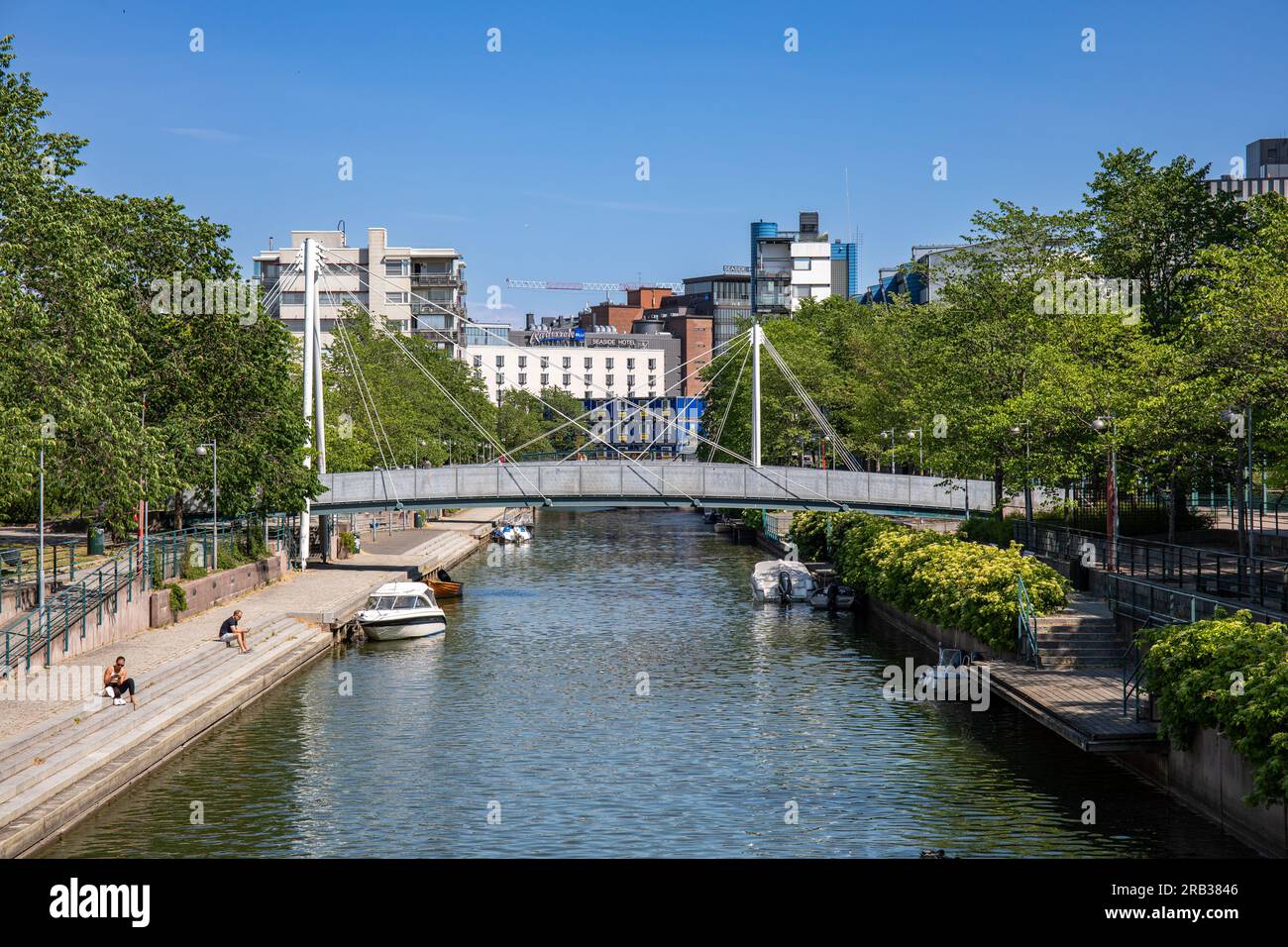 Footbridge or pedestrian bridge over Ruoholahti Canal on a sunny summer day in Helsinki, Finland Stock Photo