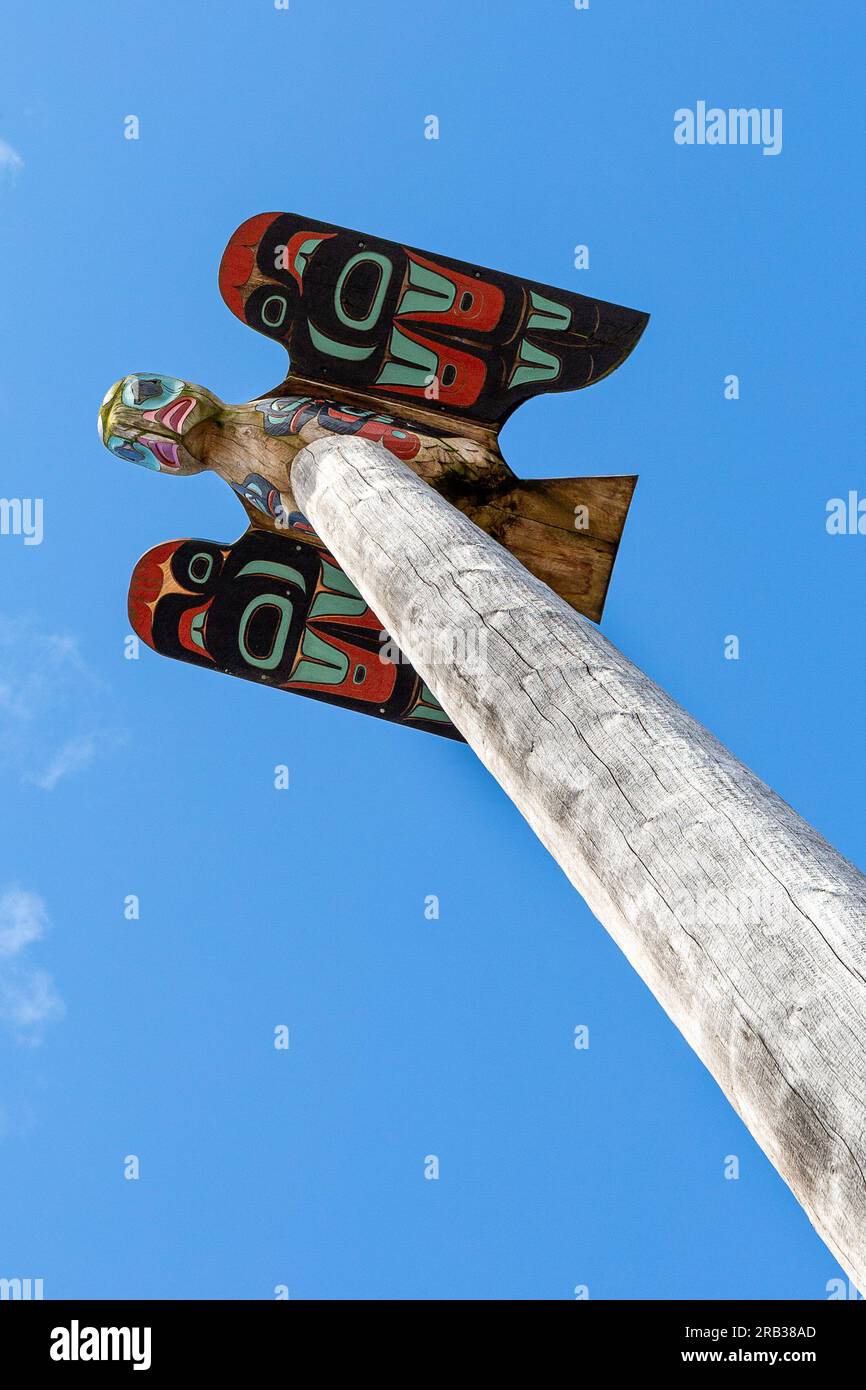 Totem poles are symbolic icons of a village's economic and cultural wealth Stock Photo