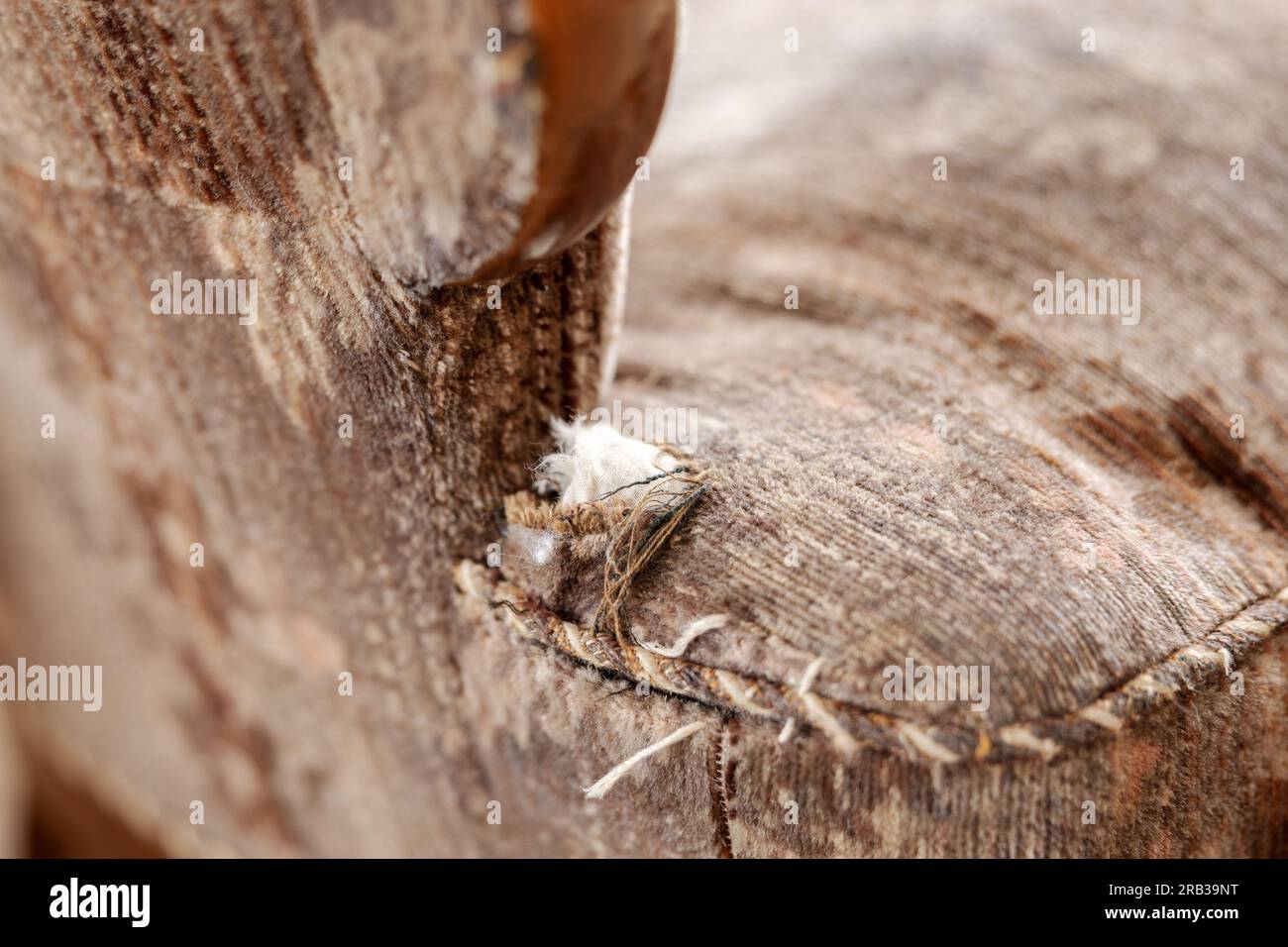 Old, damaged vintage armchair with holes in seat. Antique couch with