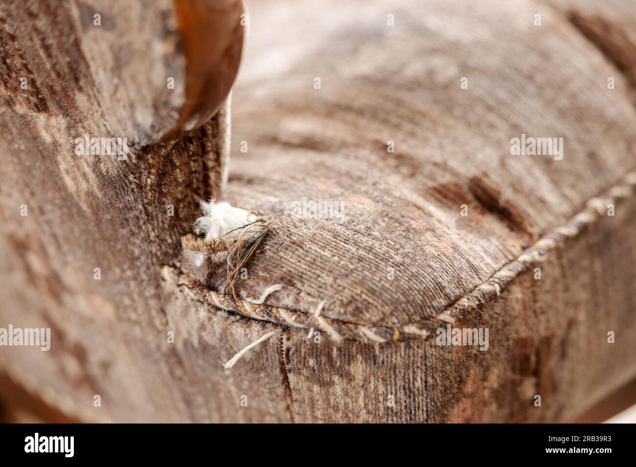 Old, damaged vintage armchair with holes in seat. Antique couch with
