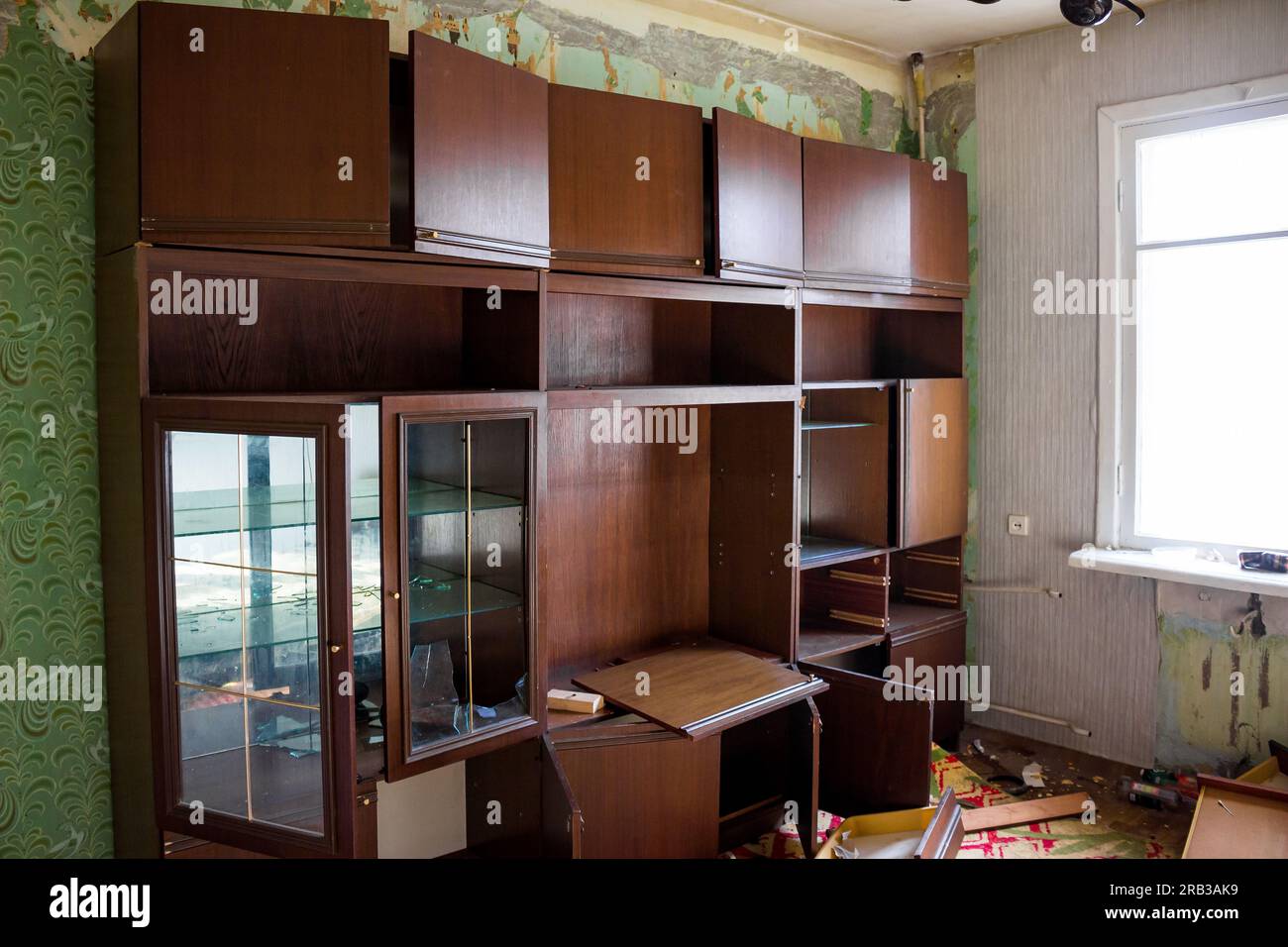 Abandoned living quarters in an old house before demolition, a mess in a dirty room Stock Photo