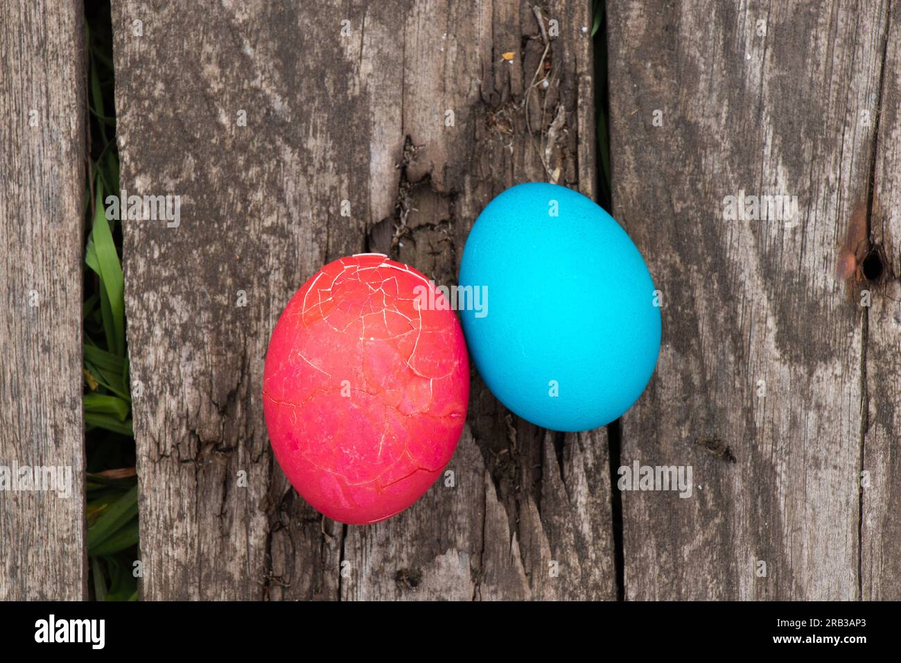 multi-colored easter eggs lie on an old wooden board, on quarantine on Easter Stock Photo