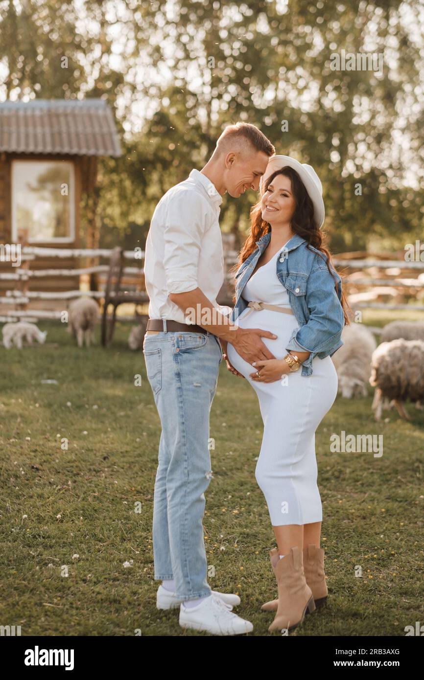 Happy man hugs his pregnant woman's belly at sunset Stock Photo - Alamy