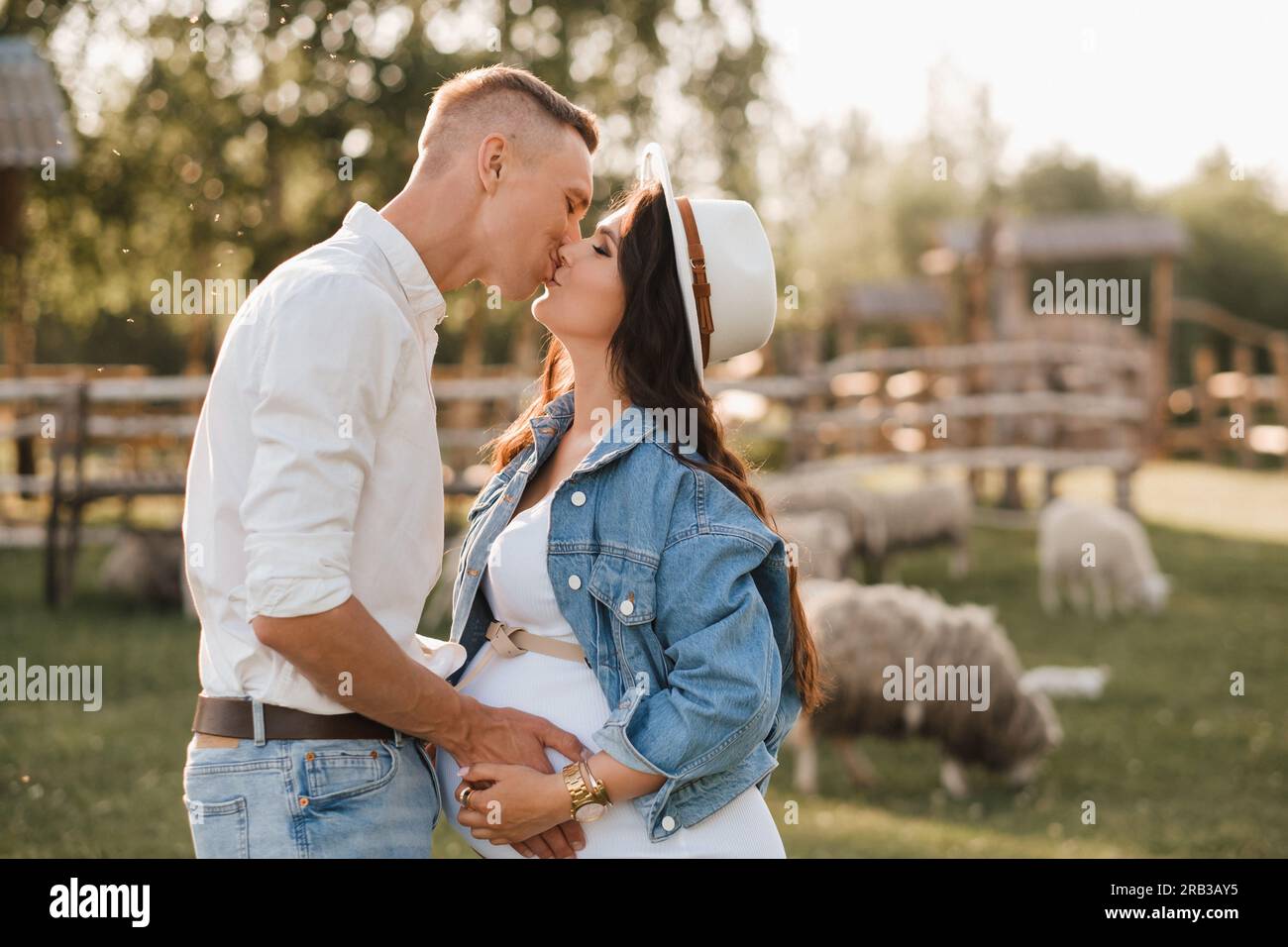 Happy man hugs his pregnant woman's belly at sunset Stock Photo - Alamy
