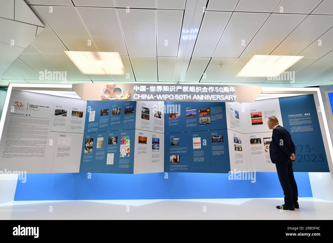 Geneva, Switzerland. 6th July, 2023. A participant views pictures at an exhibition marking the 50th anniversary of cooperation between China and the World Intellectual Property Organization (WIPO) in Geneva, Switzerland, on July 6, 2023. A series of activities marking the 50th anniversary of cooperation between China and the WIPO was held Thursday in Geneva. Credit: Lian Yi/Xinhua/Alamy Live News Stock Photo