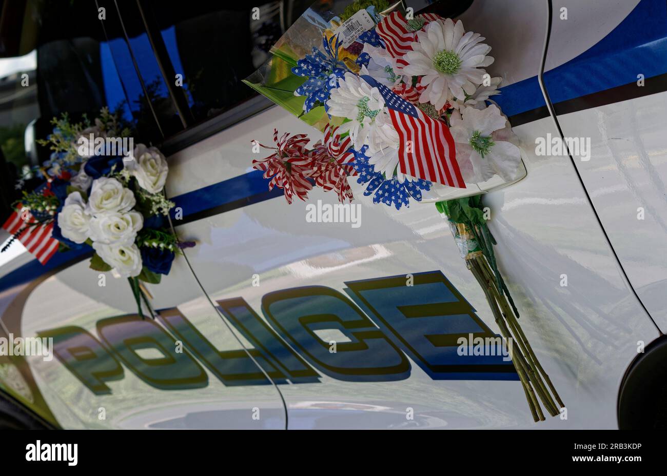 Memorial flower arrangements adorn the driver's side doors of the Dodge Durango patrol vehicle of Tell City Police Department Sgt. Heather J. Glenn on Thursday, July 6, 2023 near city hall in Tell City, Troy Township, Perry County, IN, USA. Glenn, 47, was shot and killed July 3 while trying to arrest a domestic violence suspect at a local hospital, becoming the first line-of-duty death in the Tell City Police Department's nearly 165-year history and second Indiana police officer to be killed in the line of duty in less than a week. (Apex MediaWire Photo by Billy Suratt) Stock Photo
