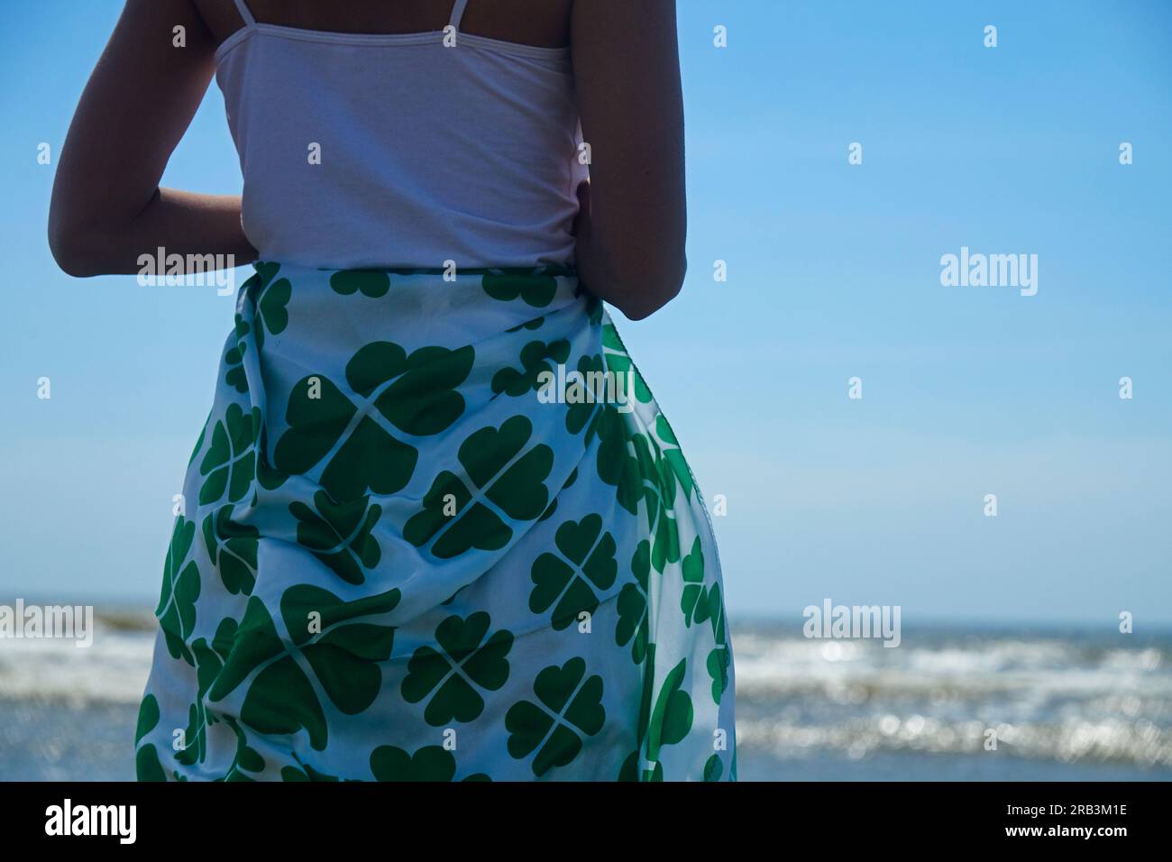 Close up of a woman wrapped in a sarong with a clover print Stock Photo