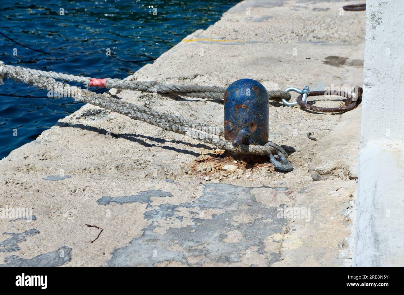 Bollard and ropes for mooring at a quay on the island Malta. Stock Photo