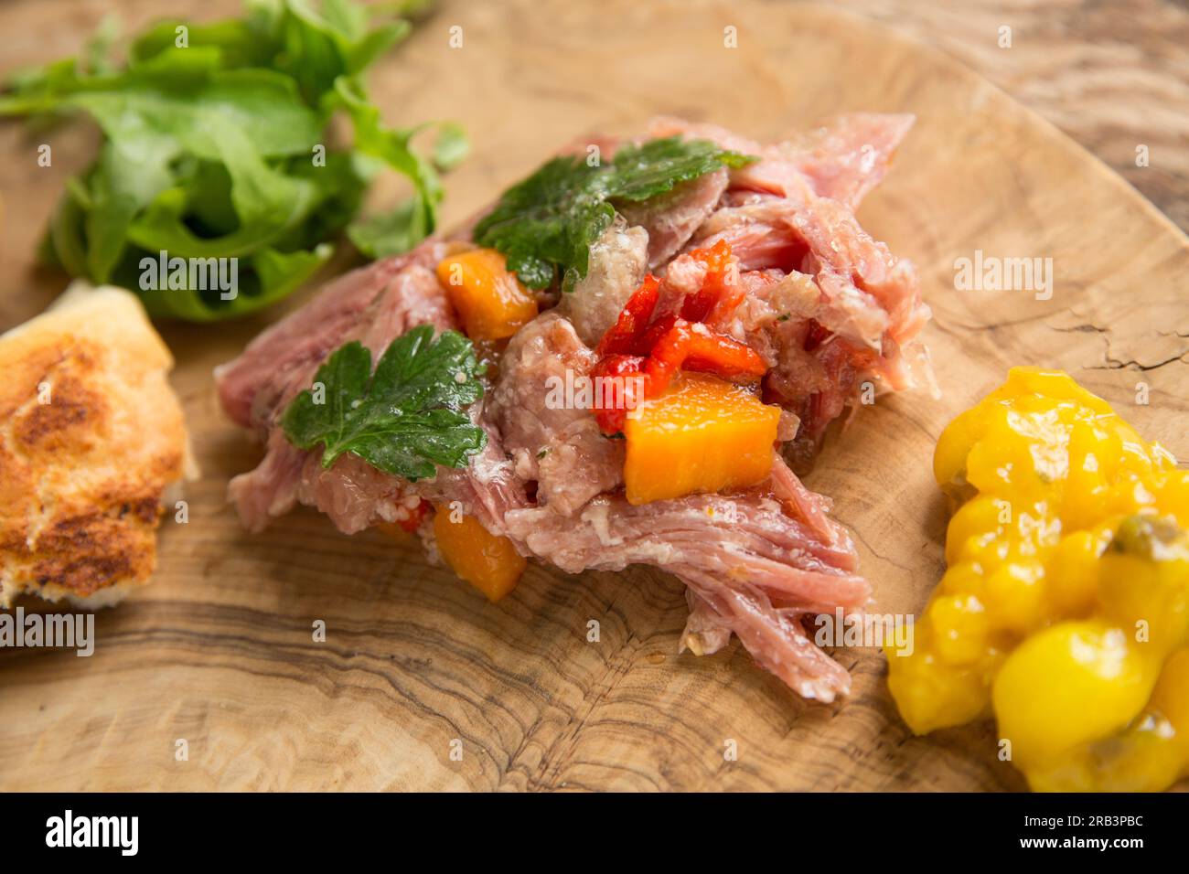 A home cooked British gammon shank that has been slow cooked in water, white wine vinegar, bay leaves, coriander seeds and black peppers to make a ter Stock Photo