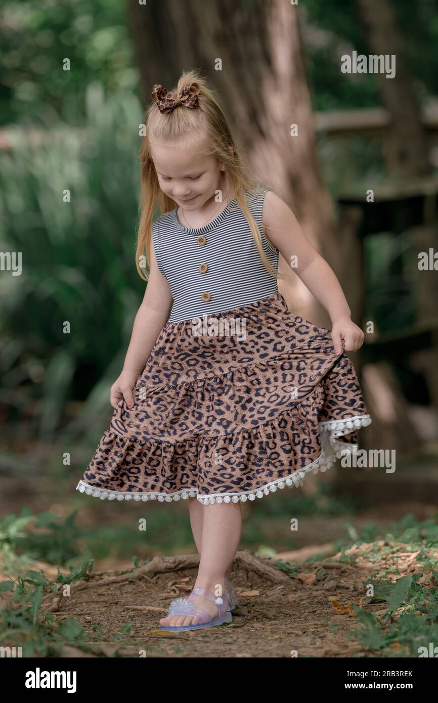 A little girl walking in the woods Stock Photo - Alamy