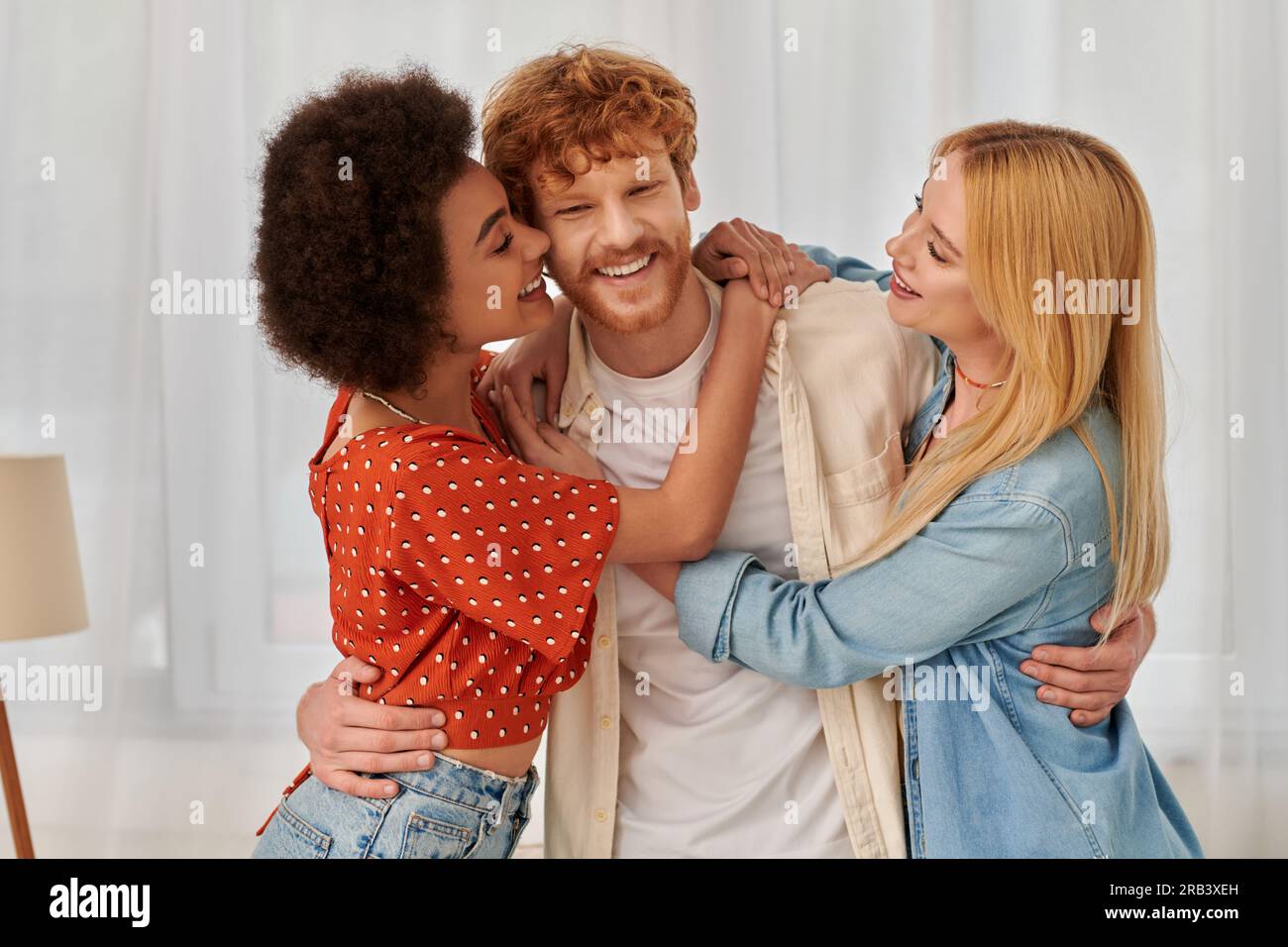 non traditional relationship, polygamy, three adults, happy interracial  women hugging redhead man, threesome, cultural diversity, acceptance,  bonding Stock Photo - Alamy