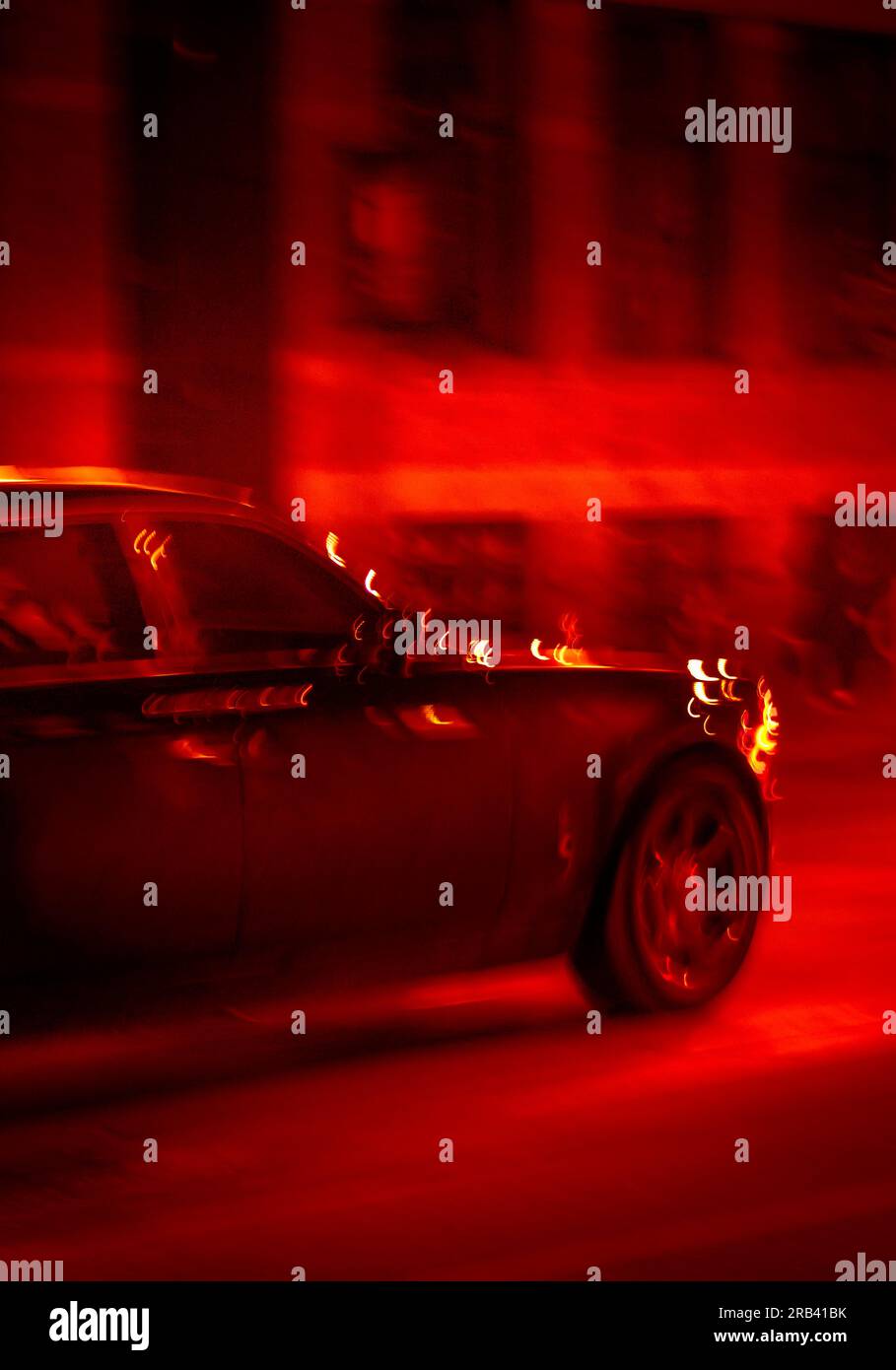 Luxury limousine speeding on a street at night Stock Photo