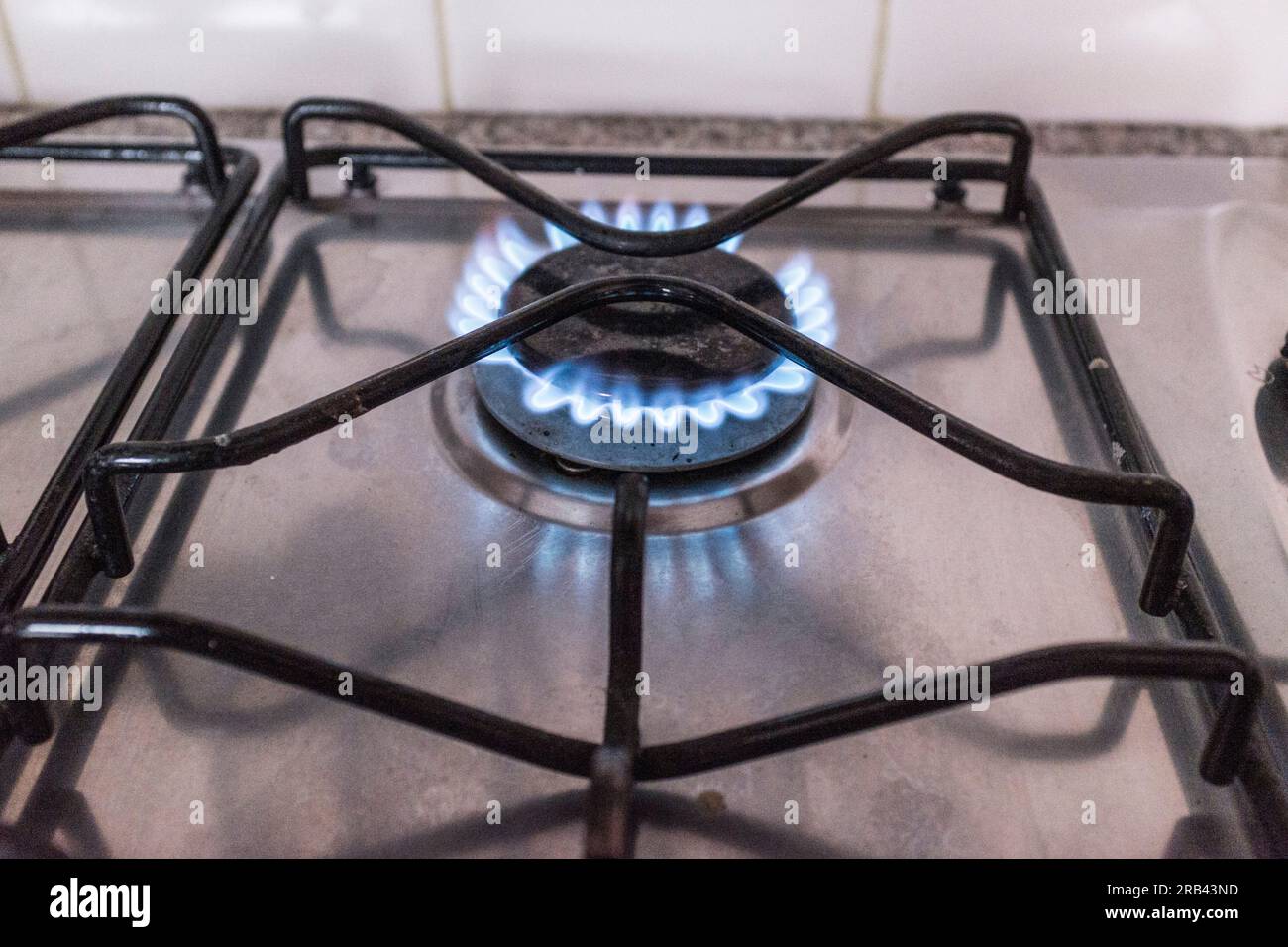 Gas hob showing blue flames Stock Photo Alamy