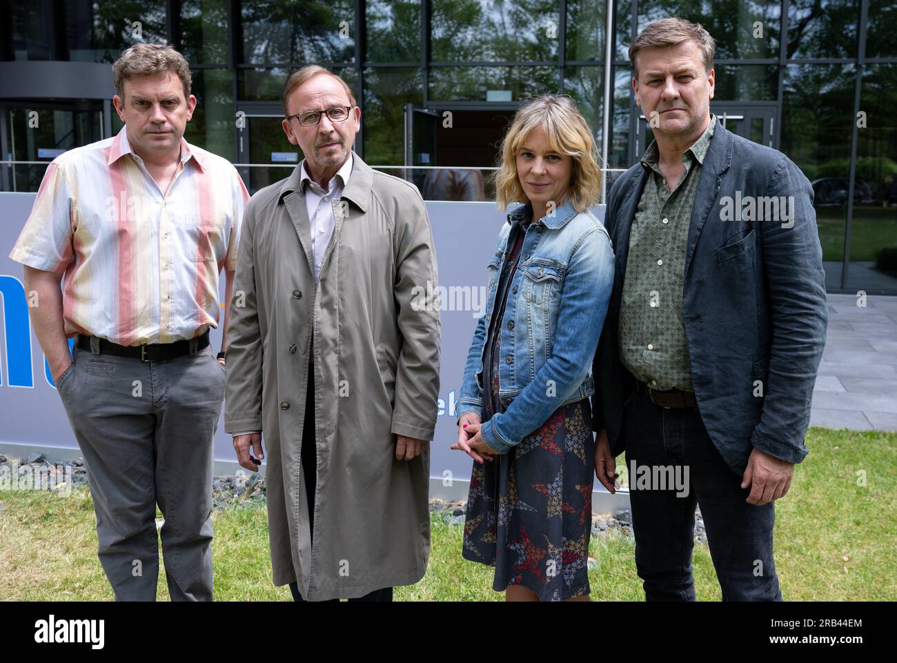 PRODUCTION - 06 July 2023, Bavaria, Munich: Sebastian Bezzel as Max Hämmerle (l-r), Alexander Held as Inspector Ludwig Schaller, Bernadette Heerwagen as Inspector Angelika Flierl and Marcus Mittermeier as Inspector Harald Neuhauser stand during a photo session on the film set of the crime series 'München Mord. Sebastian Bezzel will soon be a guest star on the ZDF series 'München Mord'. This week, filming took place in Munich-Schwabing. In the case with the working title 'Nix für Angsthasen' Bezzel plays a citizen who was once celebrated in the press as an everyday hero: Matthias Hämmerle had p Stock Photo
