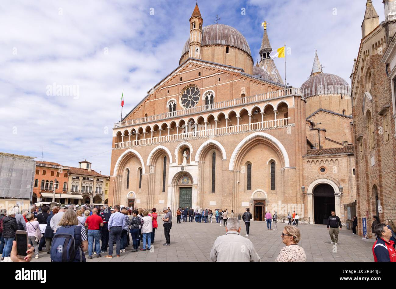 People outside the front of The Basilica of St Anthony, on a sunny day